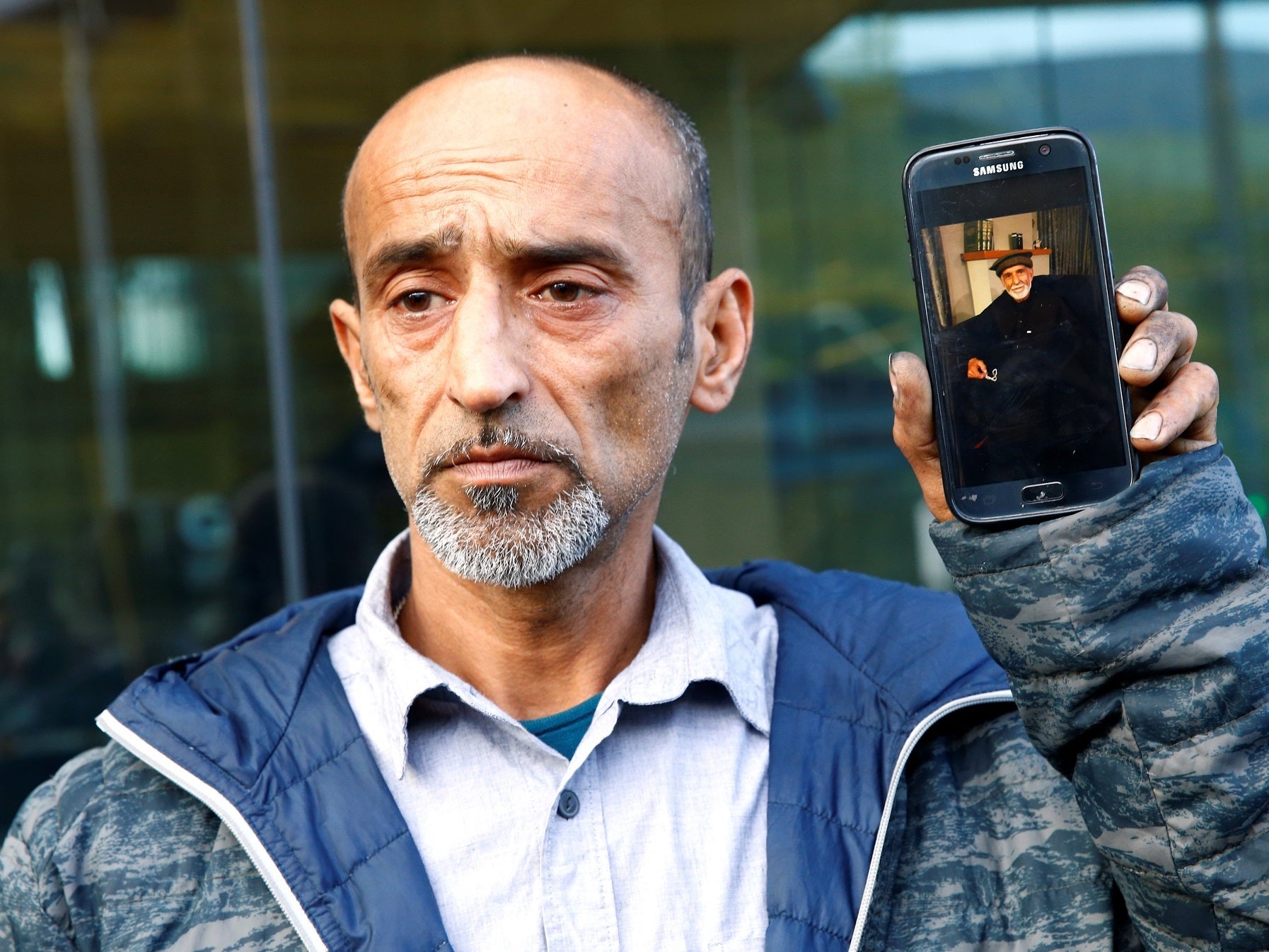 Omar Nabi speaks to the media about losing his father Haji Daoud (Reuters)