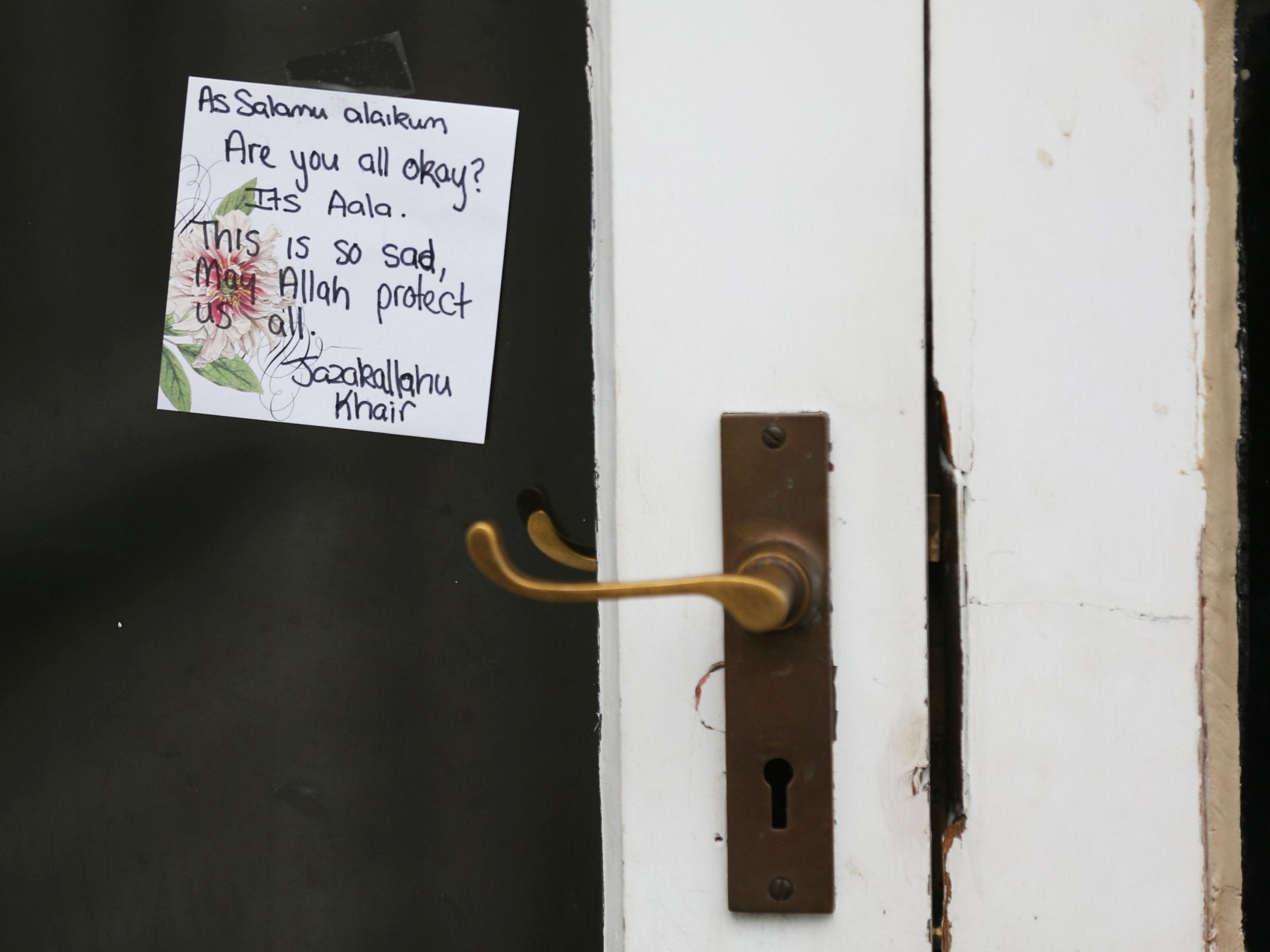 A note is seen on a window of a door at the family home of Wasseim Alsati in Christchurch on 17 March 2019.