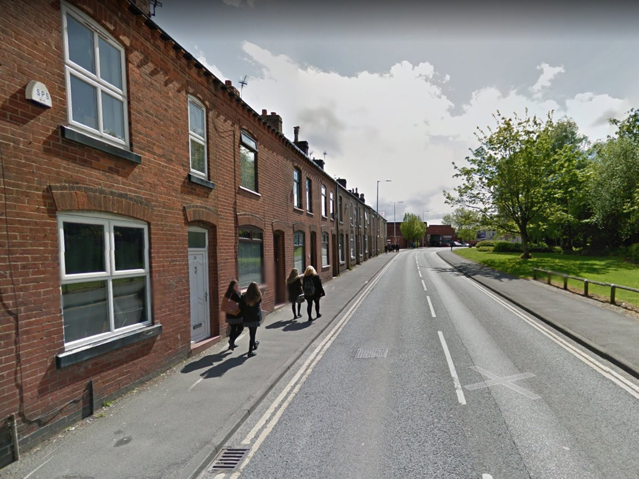 The woman was found dead with stab wounds at a property on Manchester Road in Leigh.