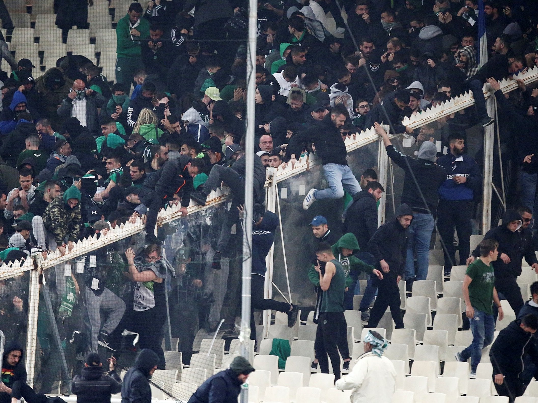 Panathinaikos fans flee tear gas fired by riot police