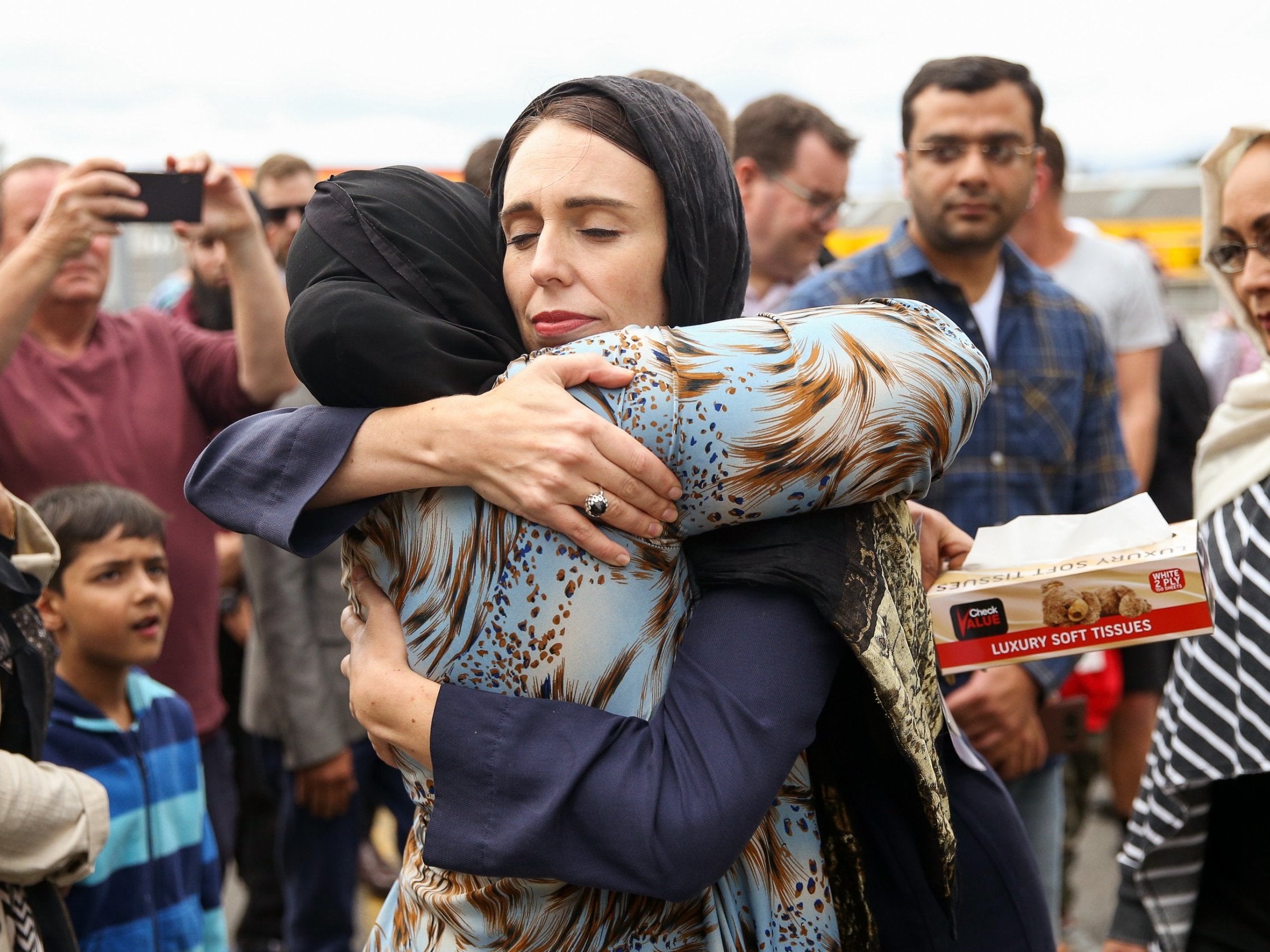 Jacinda Ardern comforts people at the Kilbirnie mosque in Wellington on Sunday