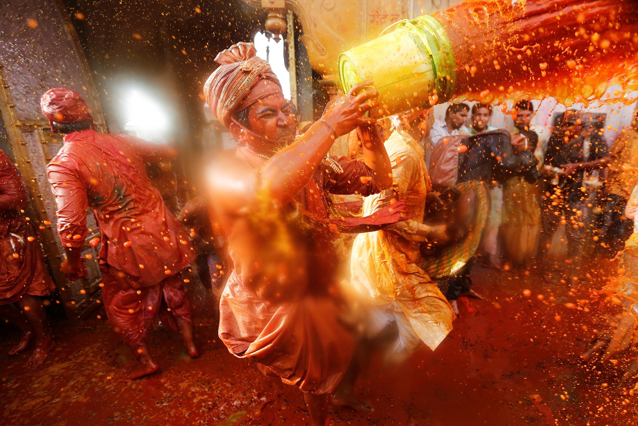 Hindu devotees celebrate Holi inside a temple in Uttar Pradesh, India