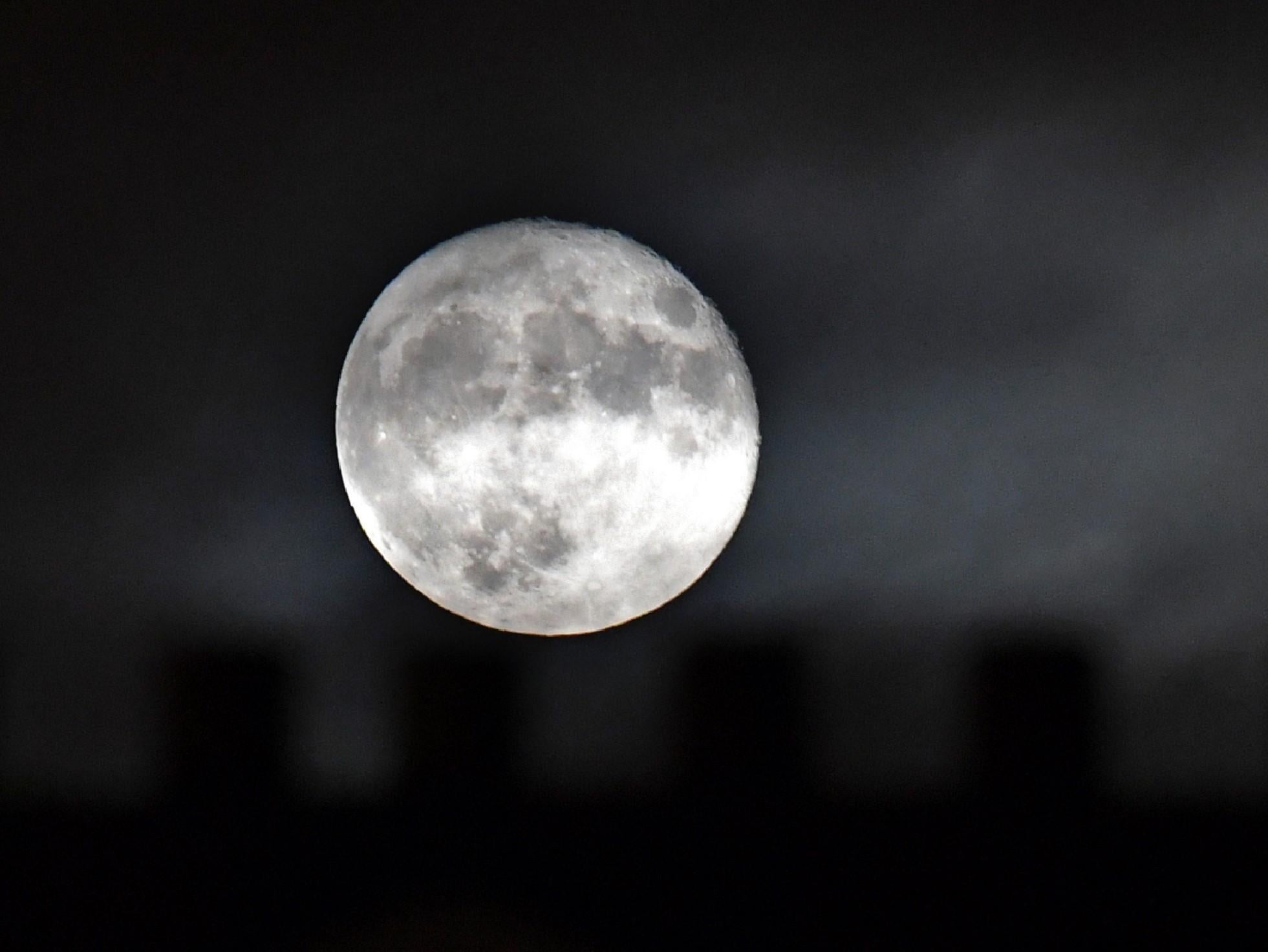 A supermoon, which occurs when a full moon passes closest to the Earth, can appear even bigger when it is close to the horizon thanks to an optical illusion