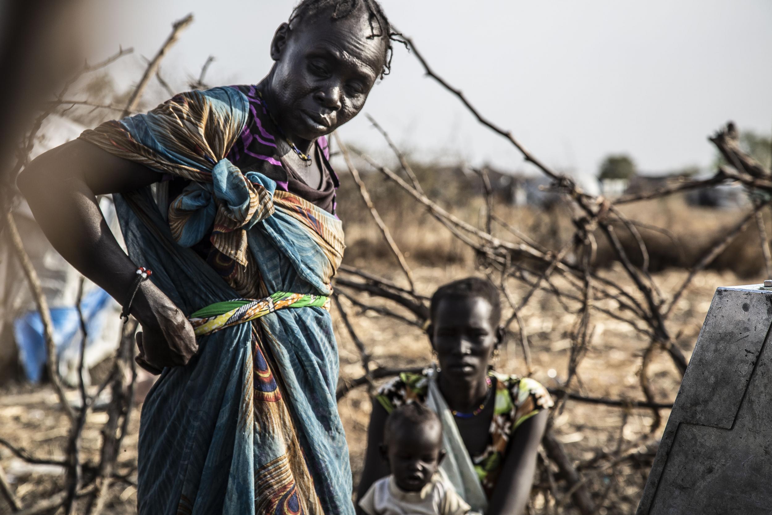 Women at a water hole in South Sudan