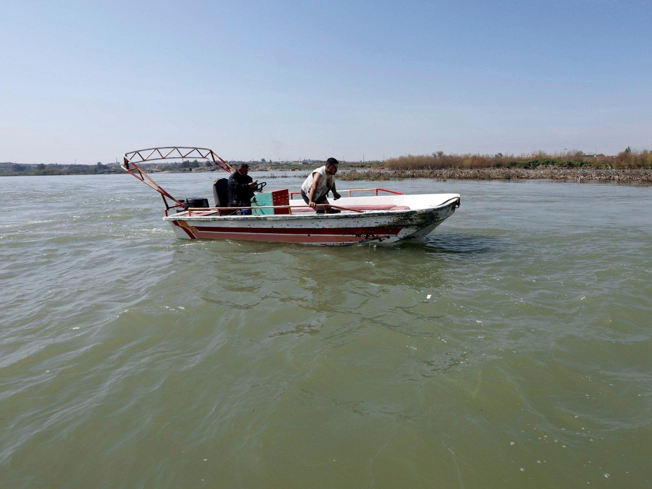 Iraqi rescuers search for victims on the site where an overloaded ferry sank in the Tigris river near Mosul, Iraq, 22 March 2019