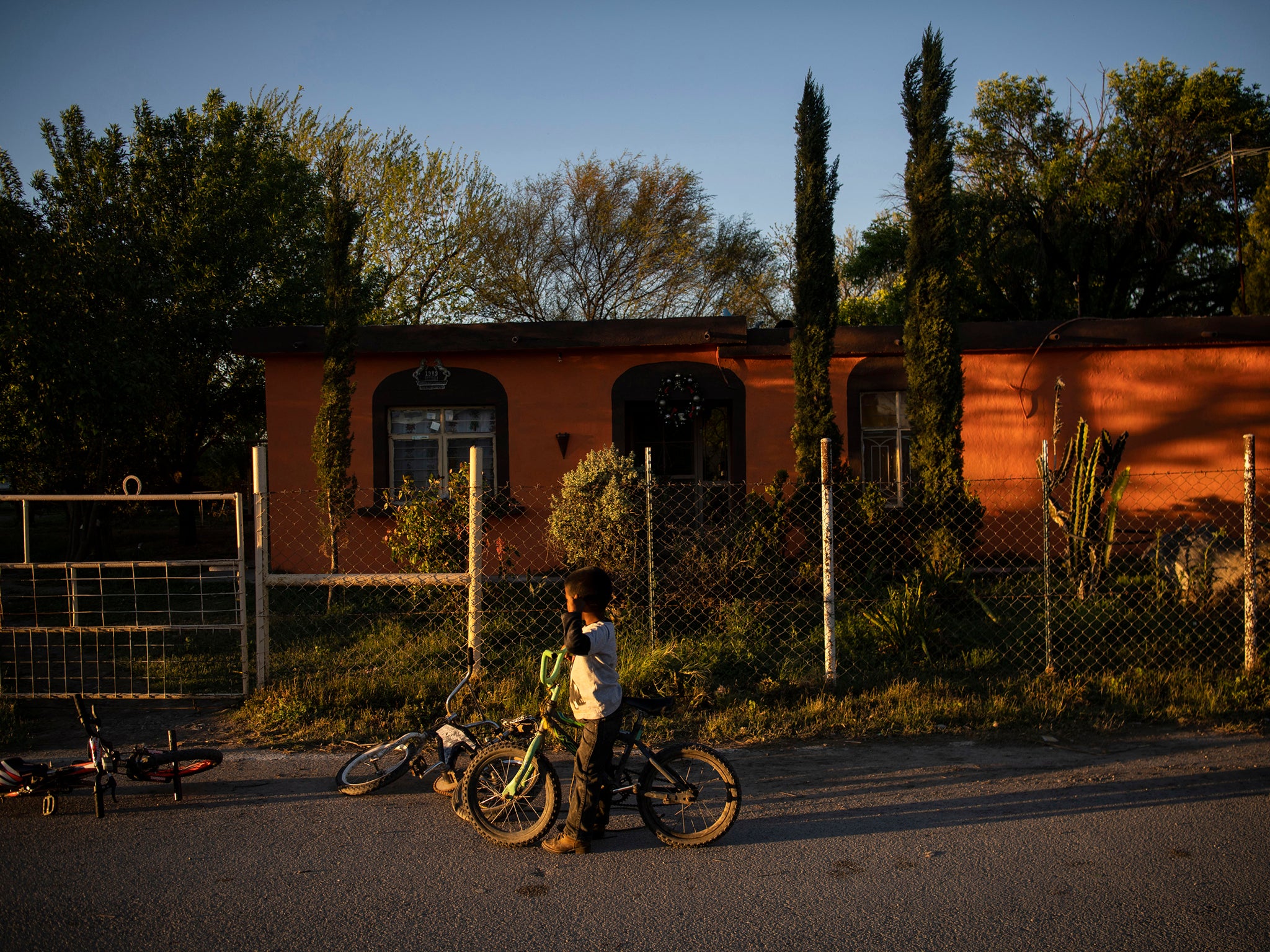 A boy rides a bike at sunset in Nacimiento