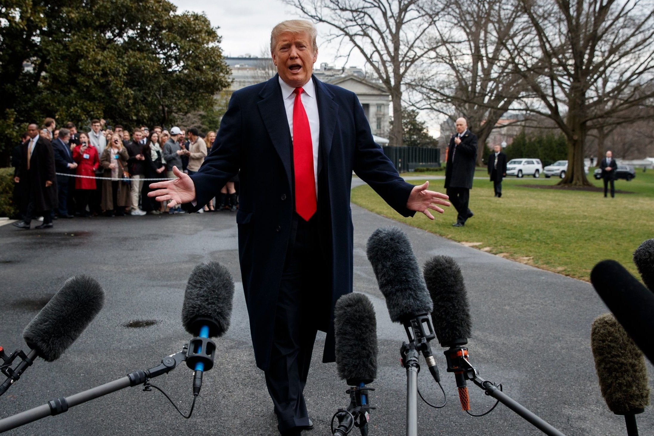 President Donald Trump talks with reporters before boarding Marine One on the South Lawn of the White House, Friday, March 22, 2019, in Washington.