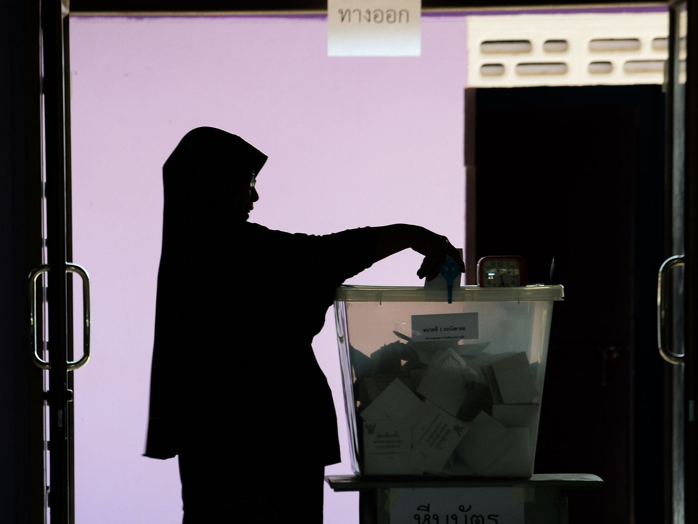 A woman casts her ballot at a polling station in Narathiwat on March 24, 2019 during Thailand's general election.