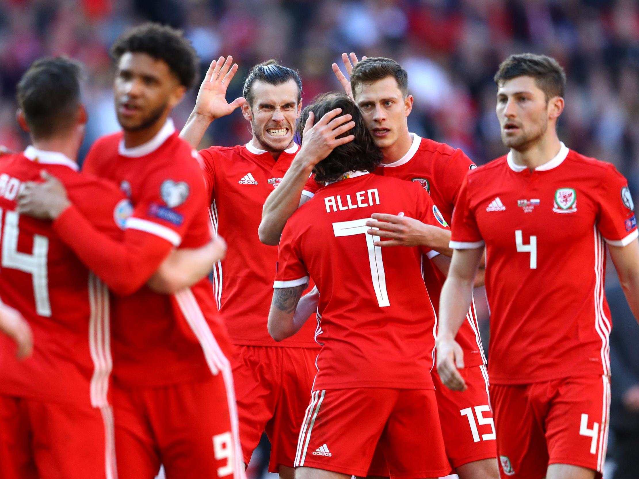 Wales' players celebrate victory after the final whistle