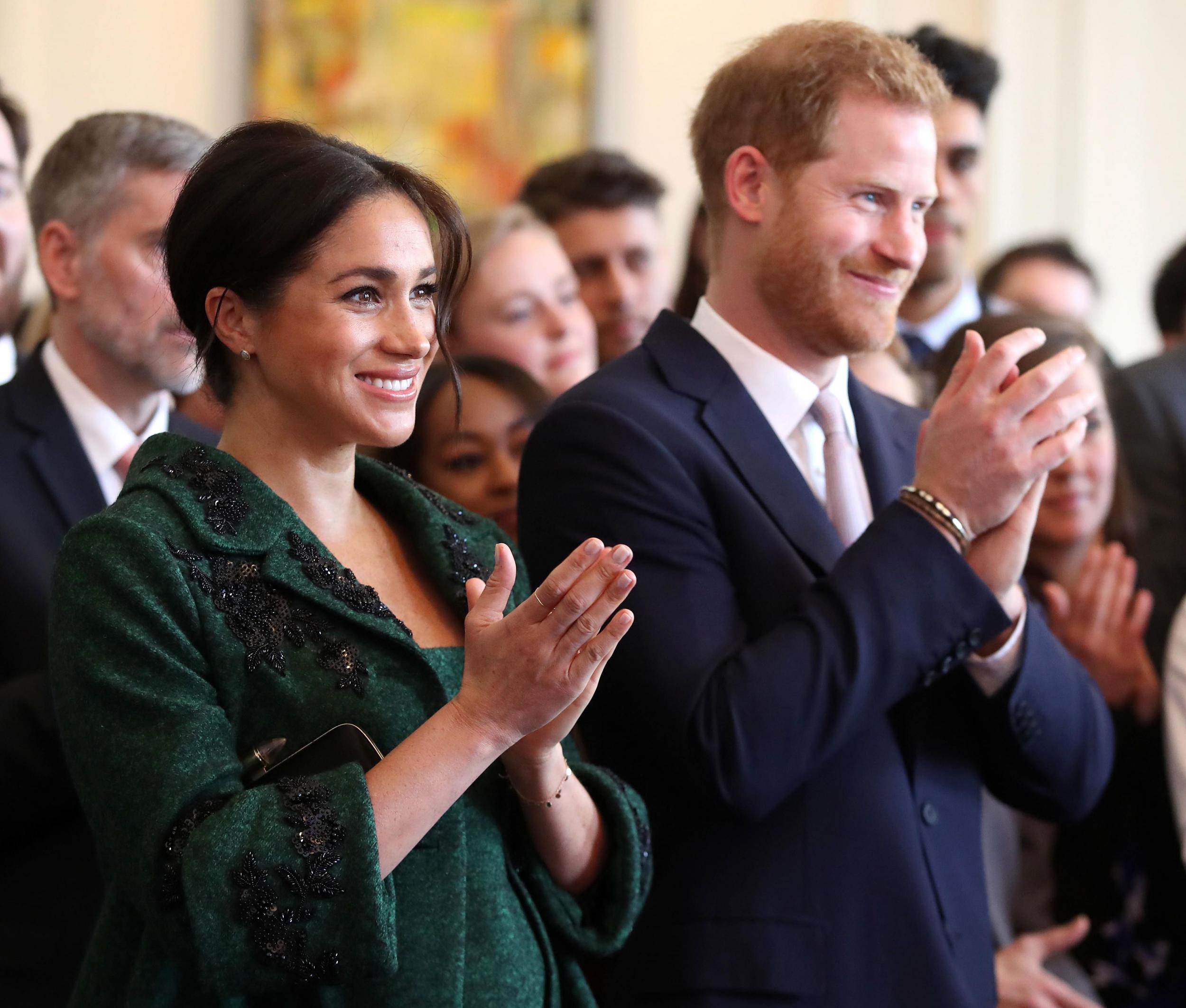 Meghan, Duchess of Sussex (L) and Britain's Prince Harry, Duke of Sussex, watch a musical performance at Canada House, the offices of the High Commision of Canada in the United Kingdom, during an event to mark Commonwealth Day, in central London, on March 11, 2019.