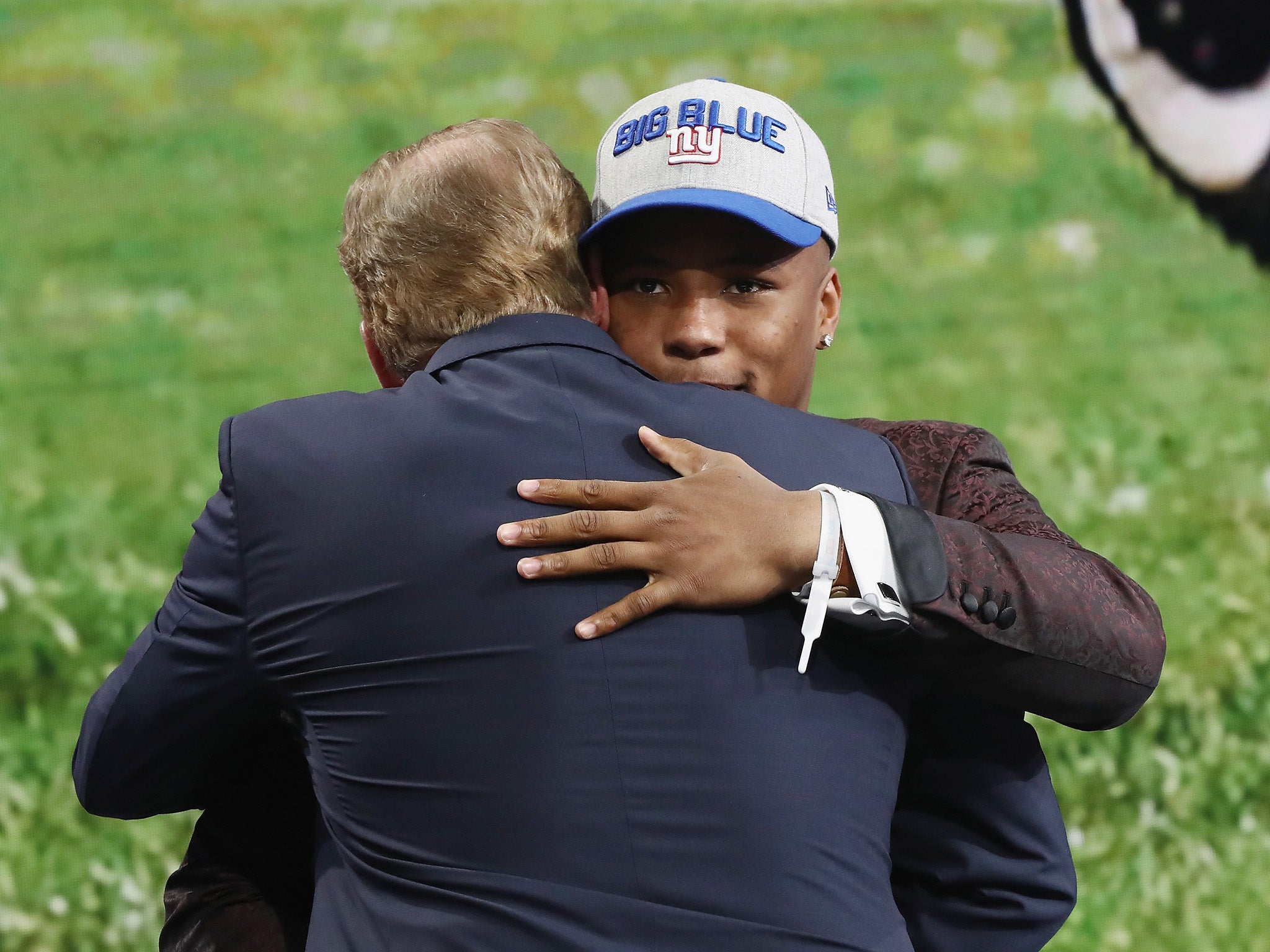 Saquon Barkley of Penn State University hugs Goodell after being picked number two overall by the New York Giants during the first round of the 2018 NFL Draft (Getty)