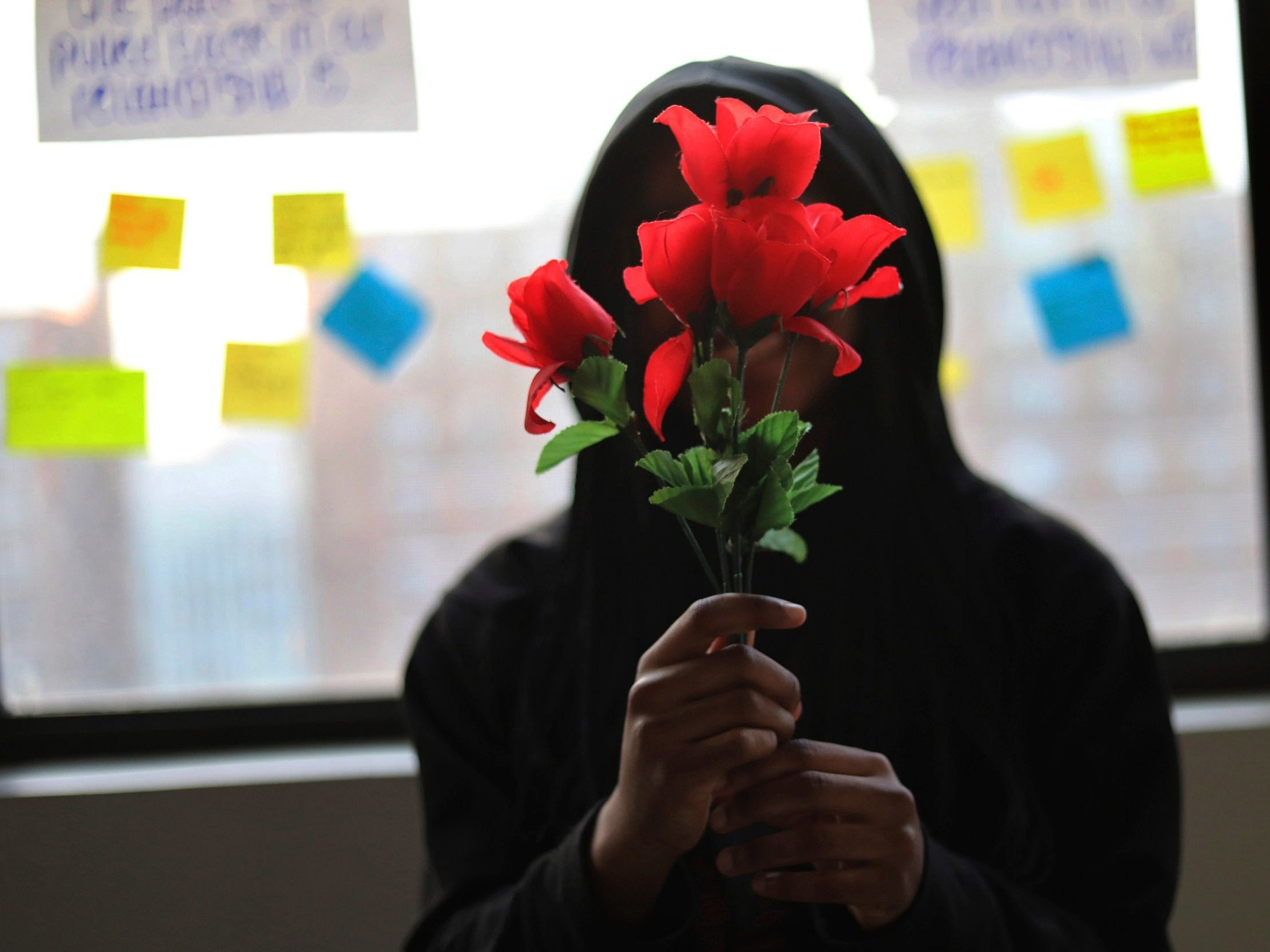 Sexual assaults and harassment on flights had started getting increased attention thanks to the #MeToo movement. Pictured: A survivor of sexual assault holds plastic flowers after attending a meeting with the group "Sisters in Strength" in the Brooklyn borough of New York on Thursday 14 March 2019.