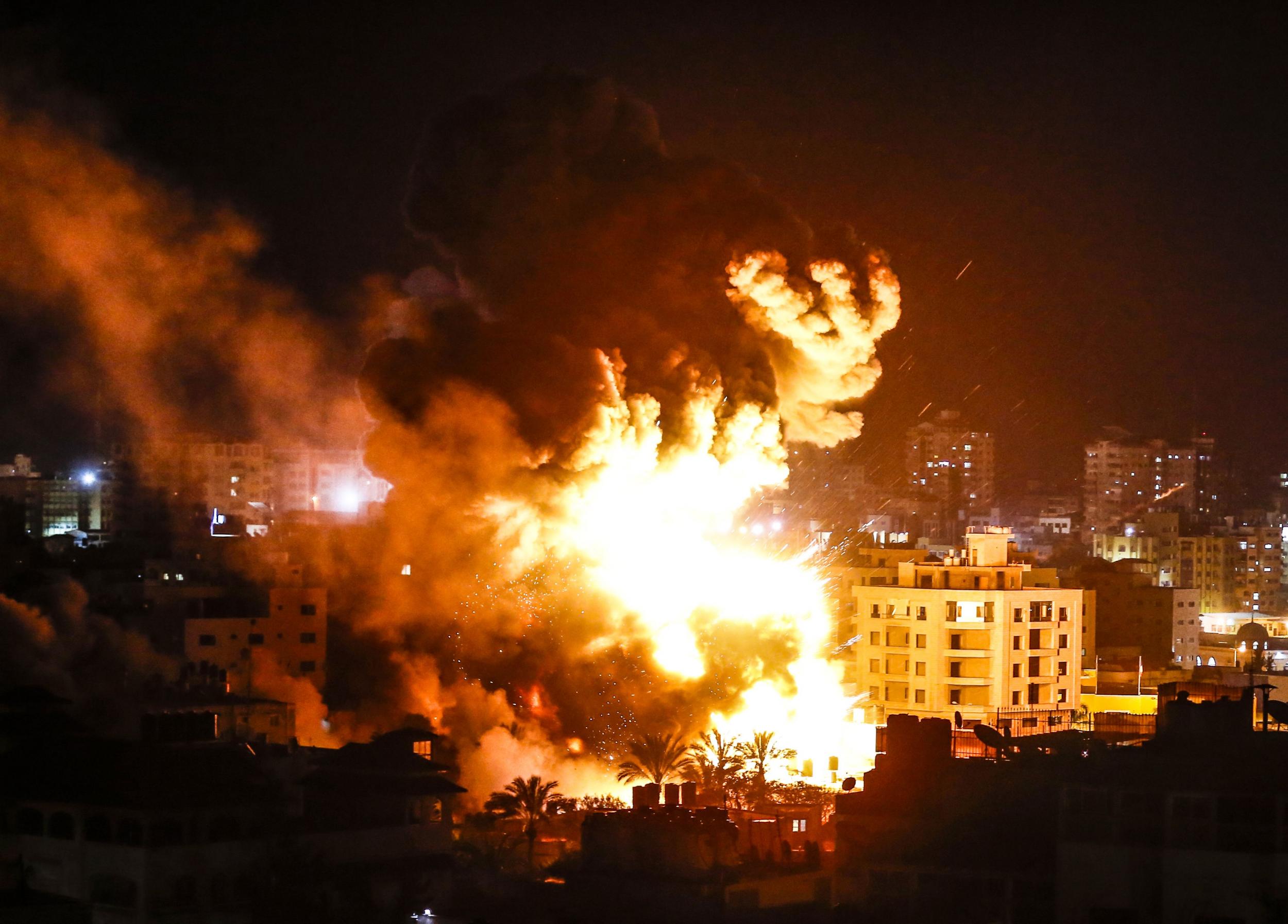 Fire and smoke billow above buildings in Gaza City during reported Israeli strikes on March 25