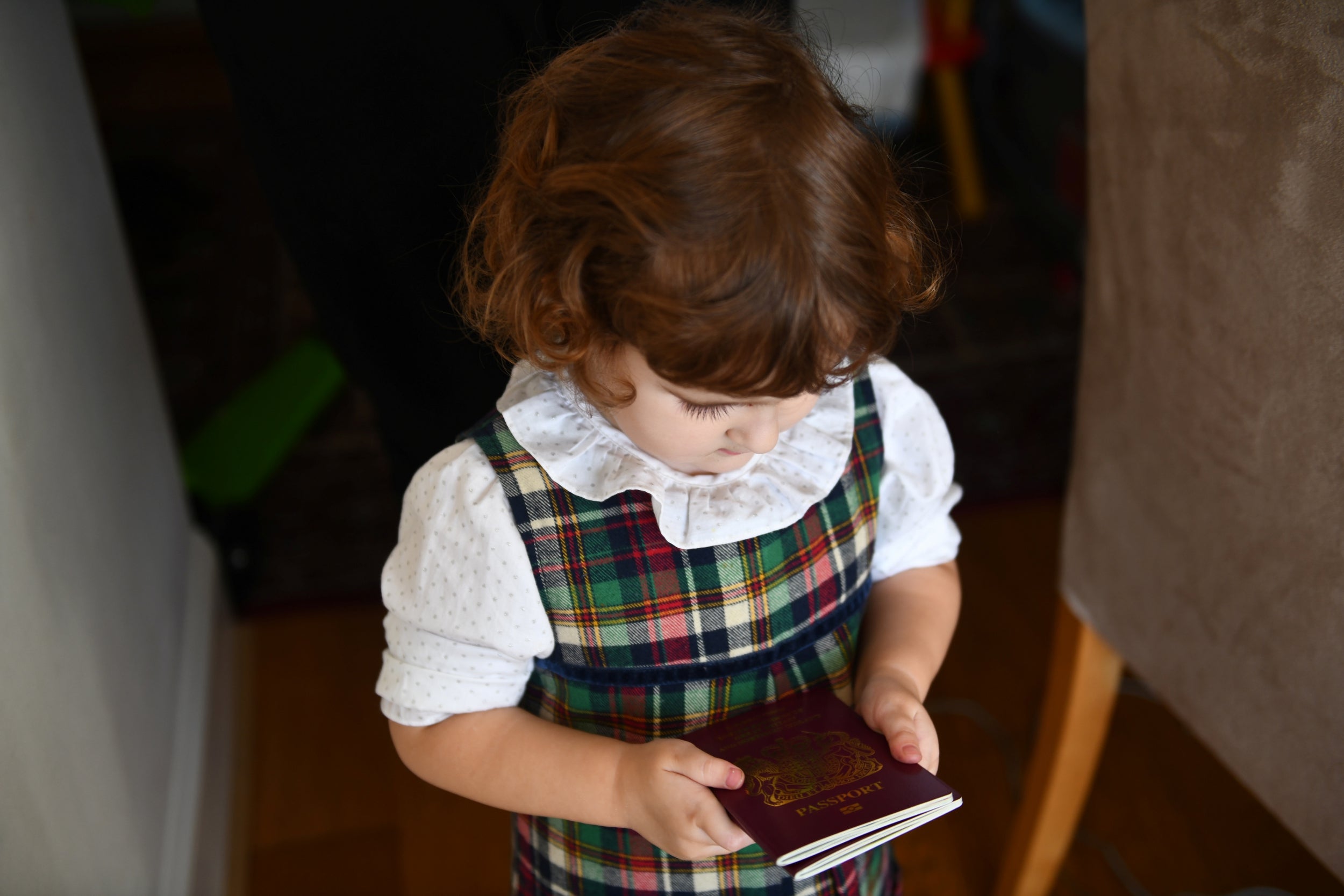 Elena holds up British passports belonging to her and her sister. Both children have dual citizenship, but their parents do not want to apply for this despite having permanent residency in Britain