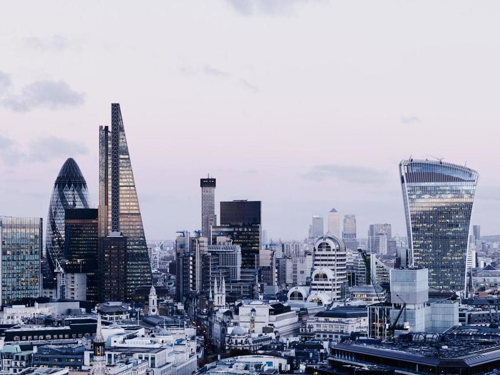 City Of London skyline at sunset, with cloudy sky