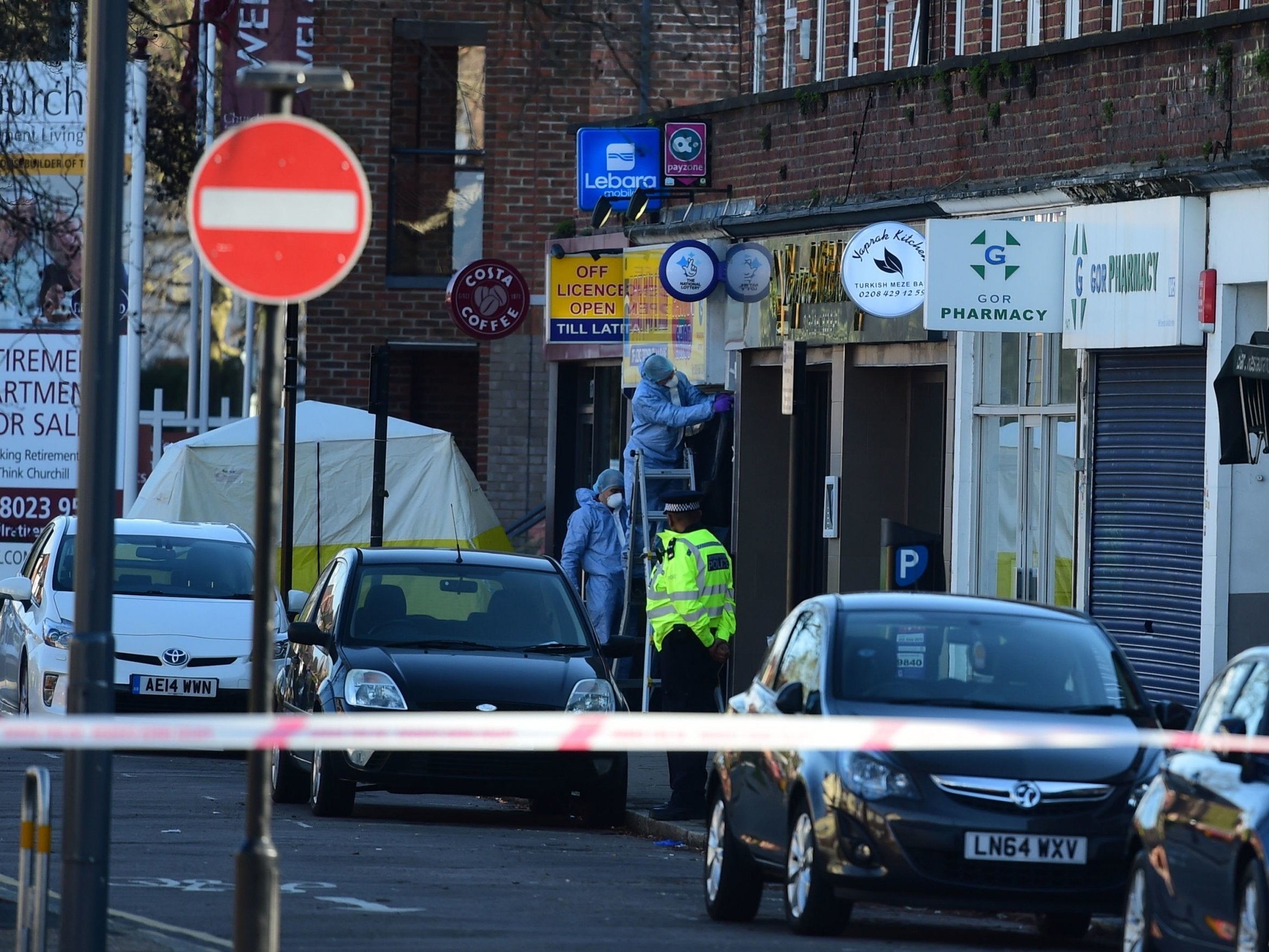 Forensic officers in Marsh Road, Pinner, north-west London, after the attack