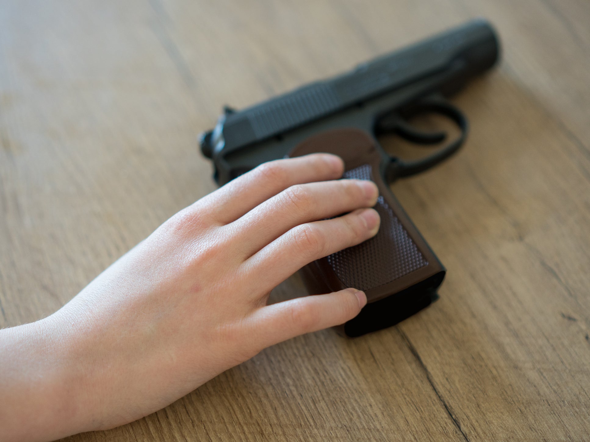 File image of child holding handgun.