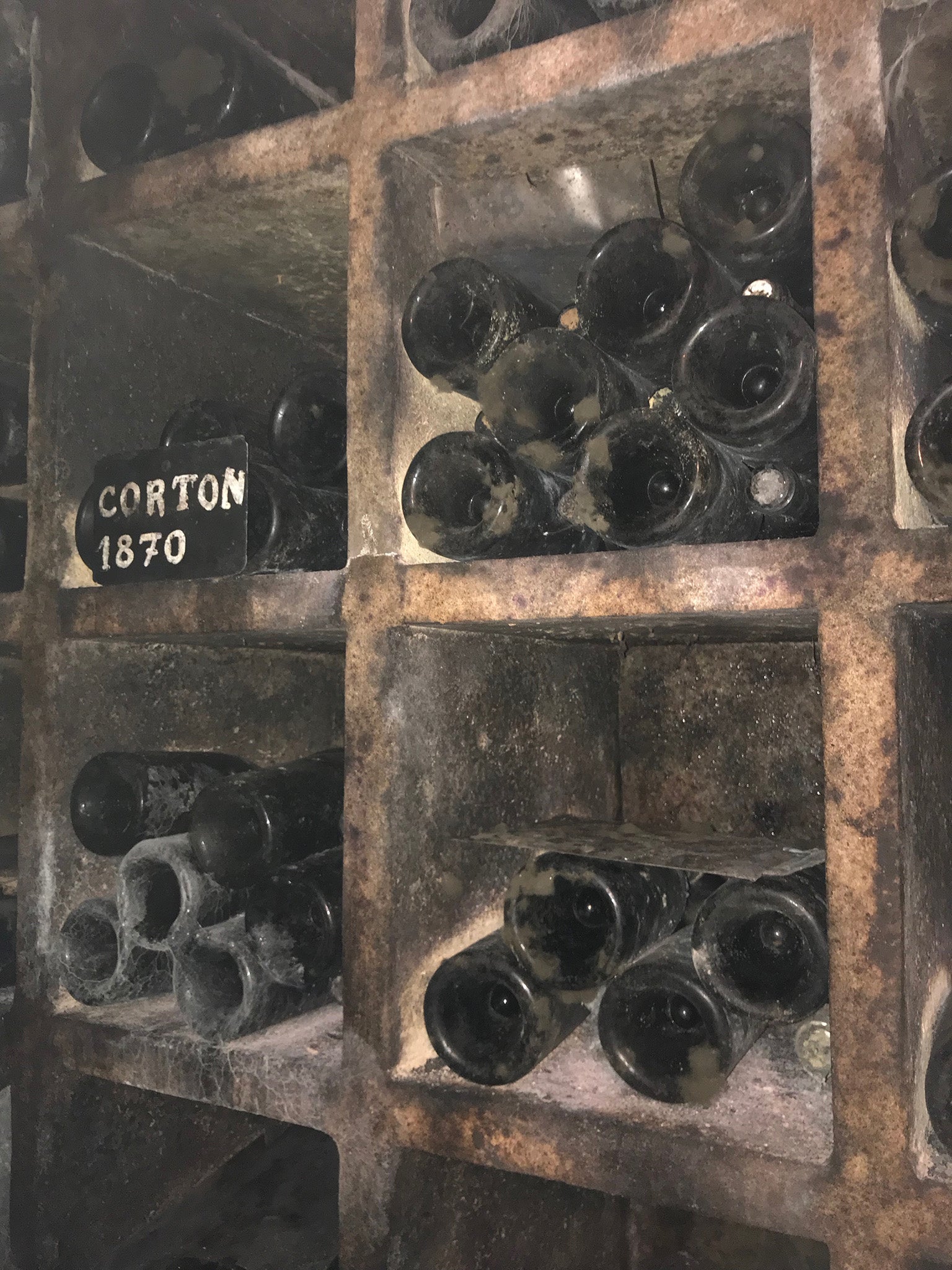 A cellar at Chateau Alexe-Corton laden with vintage wines