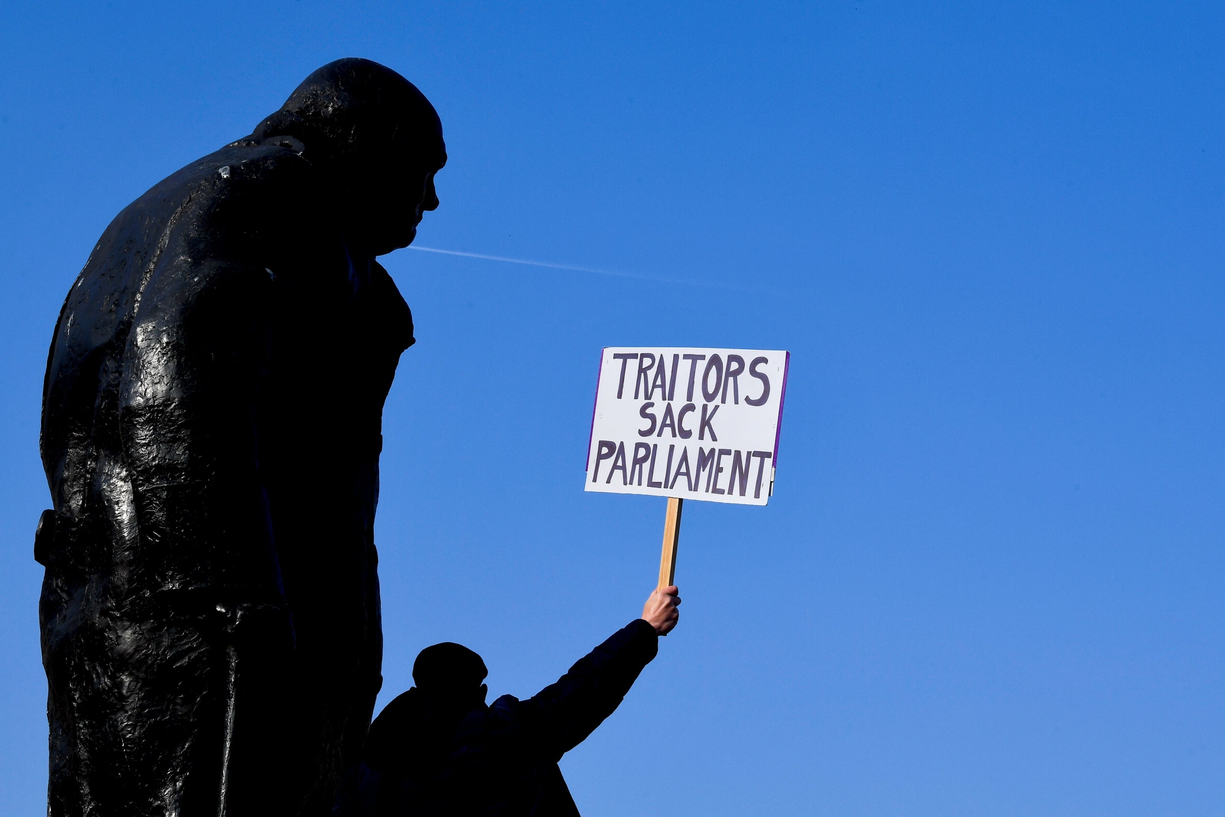 One man climbed onto the Churchill statue on Parliament Square to make his point