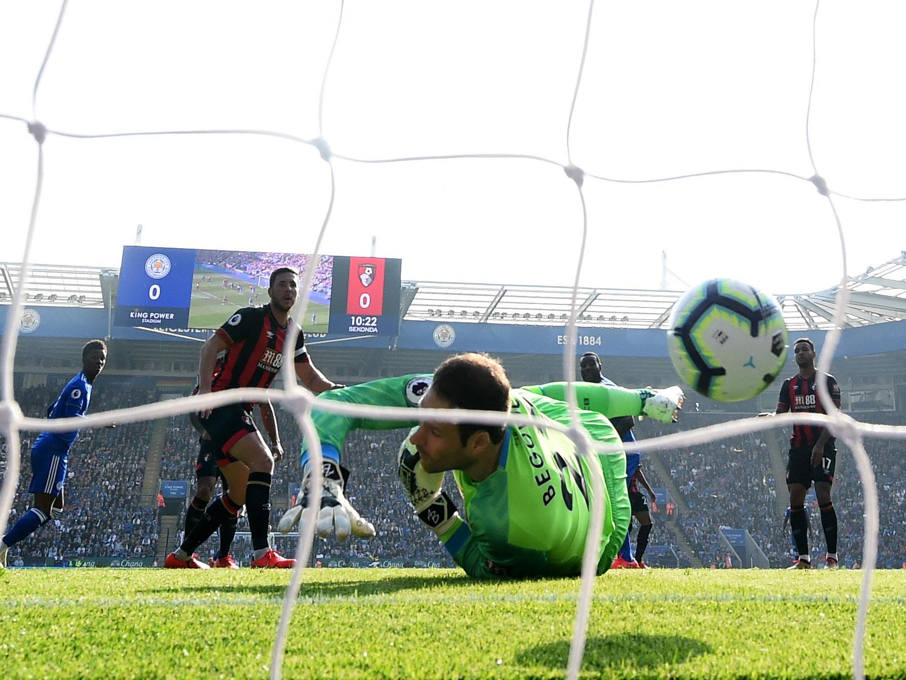 Asmir Begovic reaches for the ball after being beaten by Wes Morgan