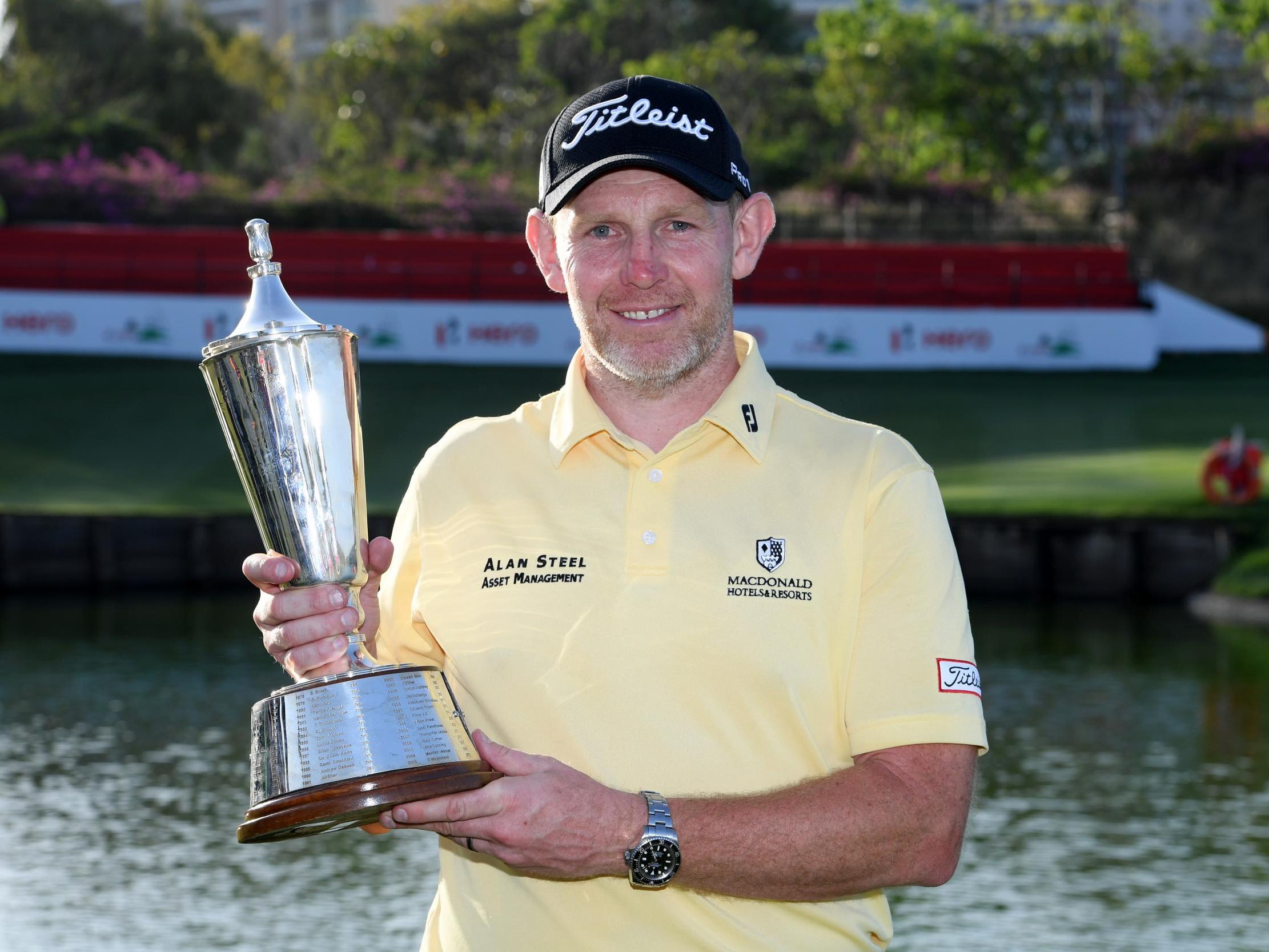 Stephen Gallacher holds the trophy in New Delhi