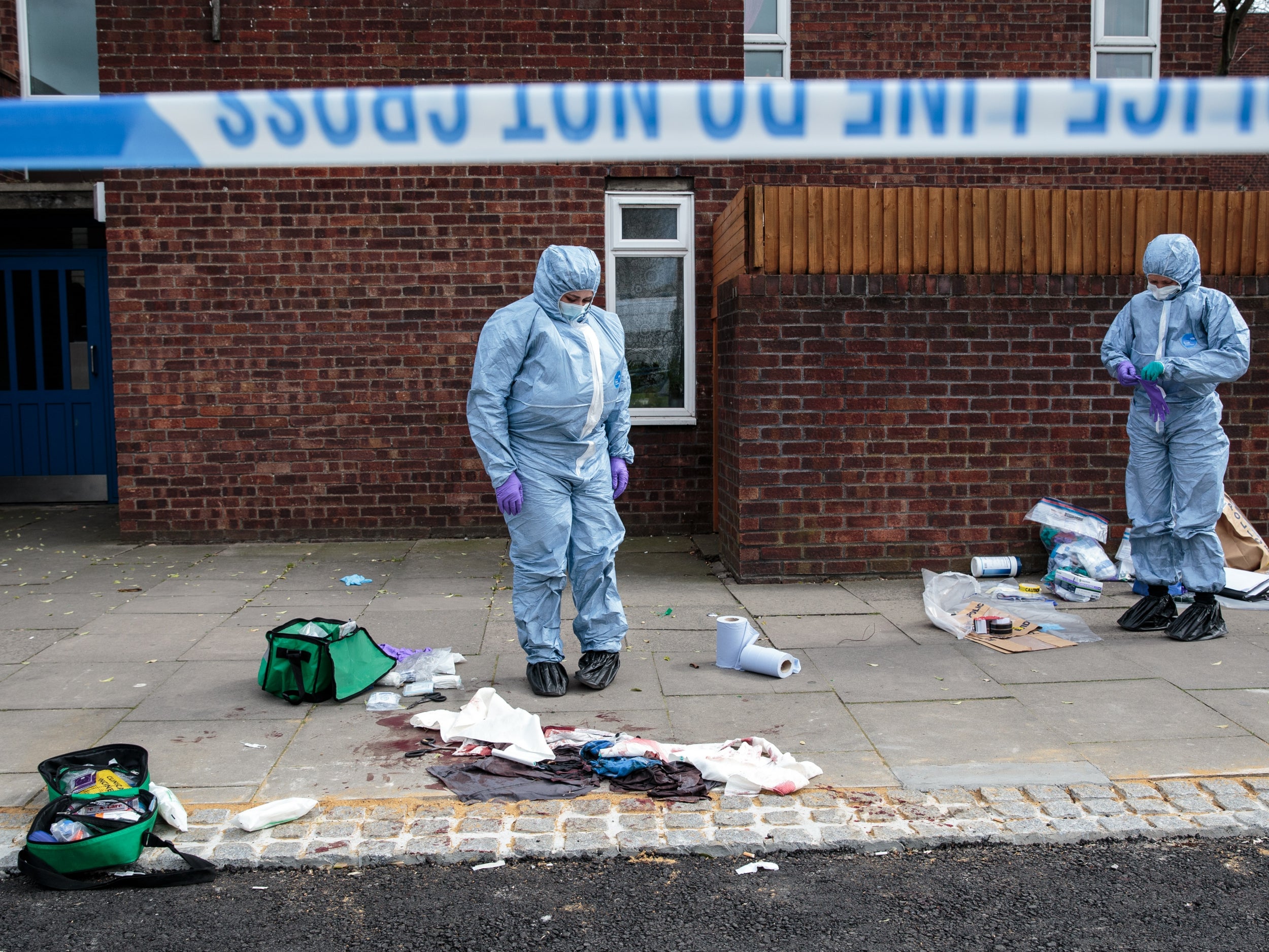 Forensics teams work at the scene of a stabbing in Edmonton (Getty )