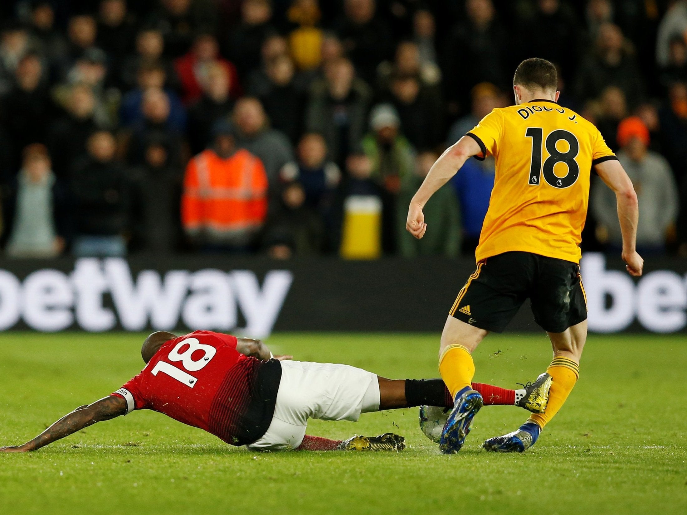 Ashley Young crashes into Wolves forward Diogo Jota