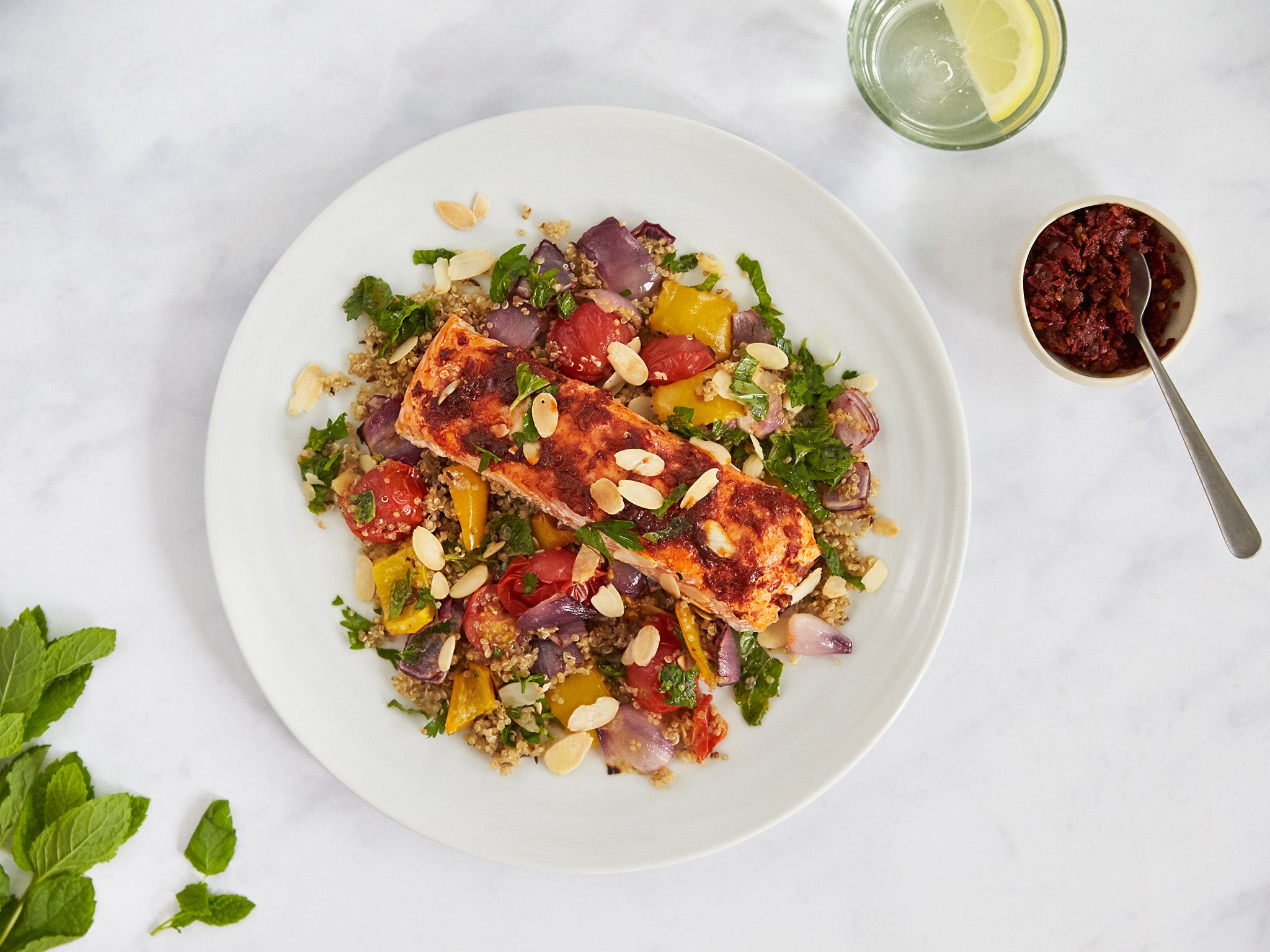 Harissa salmon herb dressing and veggie quinoa