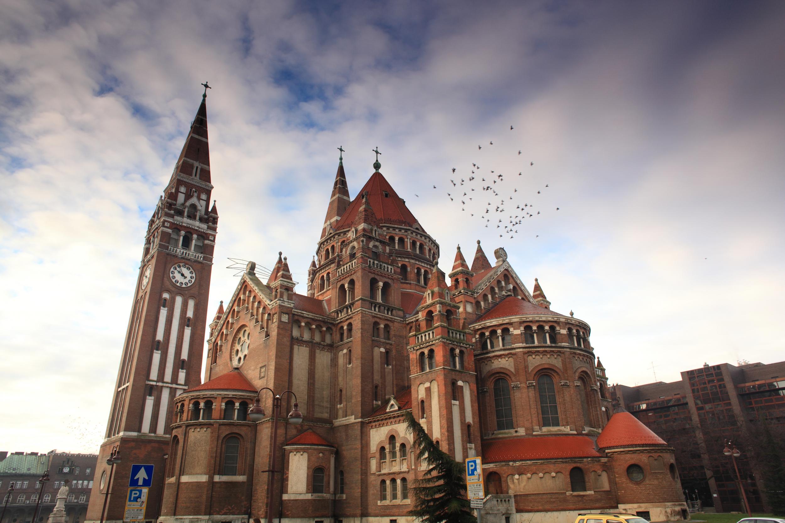 Swing by Szeged Votive Church to see the unique clocks