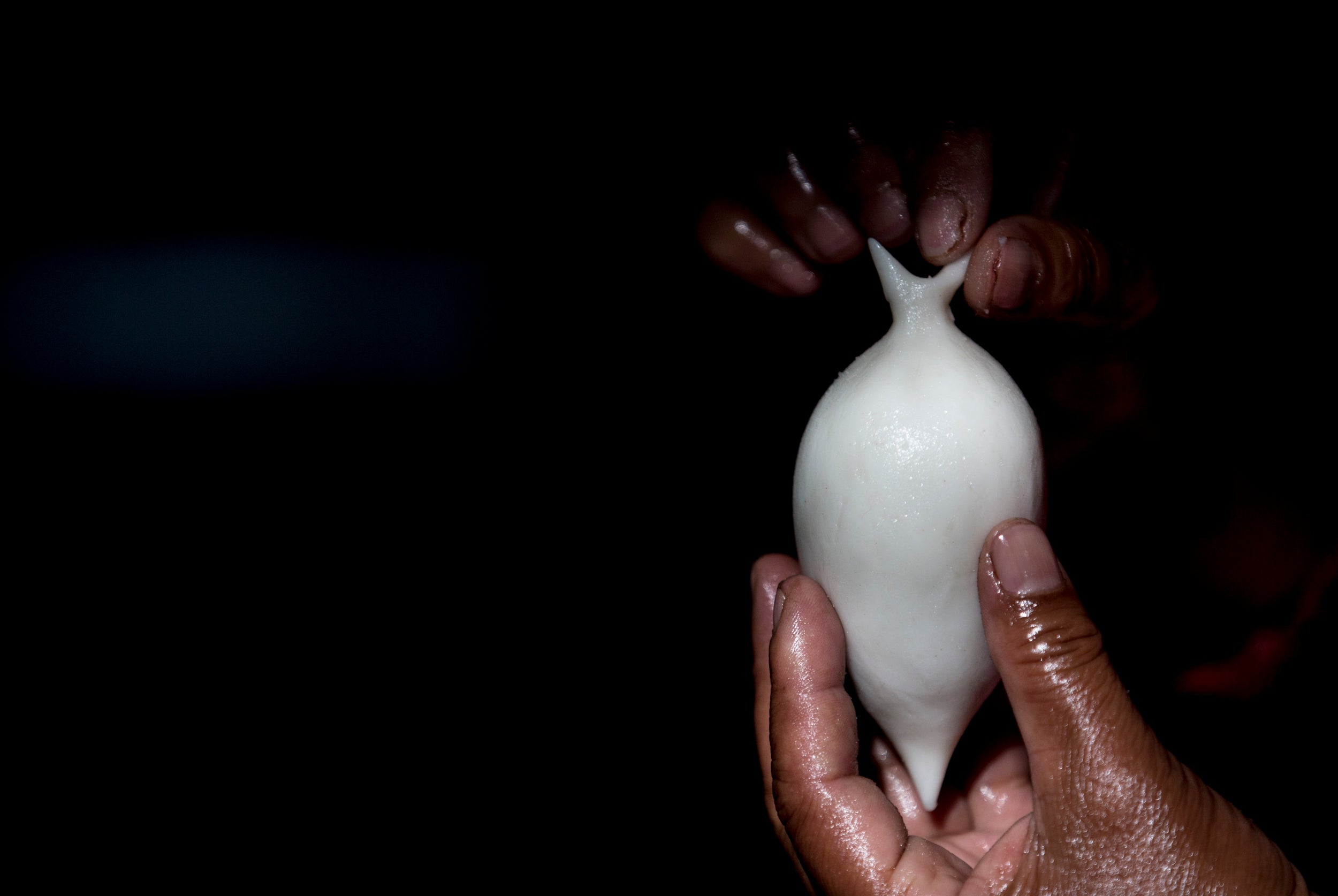 A woman prepares yomari, or Nepalese steamed dumplings, in Lalitpur. Yomari consists of an external cover of rice flour and an inner content of sweets known as chaku and the mild-based khuwa. They sell for about 65 Nepali rupees or 60 US cents per dumpling. The yomari were traditionally prepared as a specialty dish by members of the ethnic Newari community in Nepal for their festival, but demand became so great that they are now sold throughout the year. According to myth Kubera, the Hindu god of wealth and prosperity, liked the yomari so much upon tasting it that he foretold anyone who makes it will be blessed with wealth and prosperity