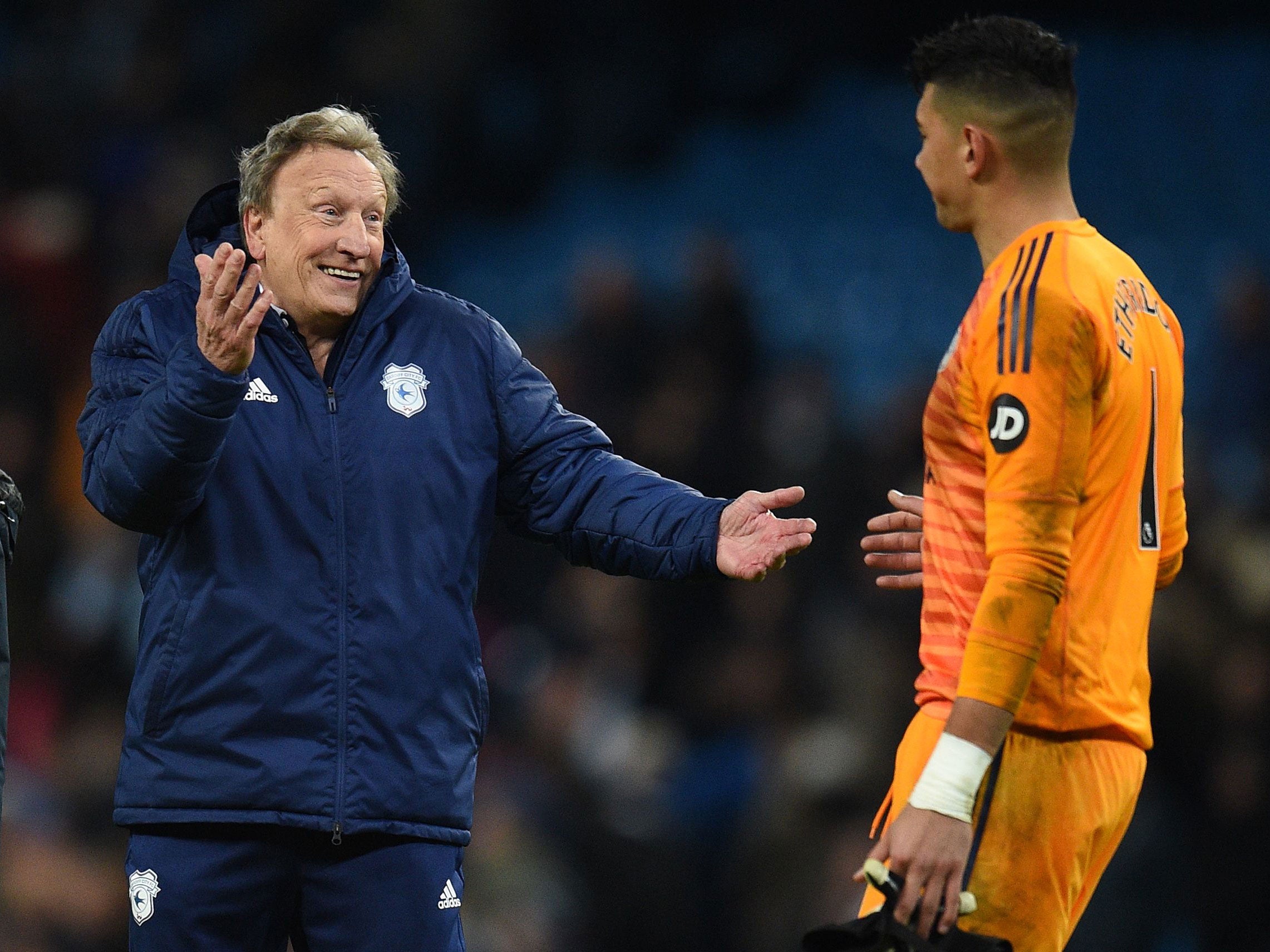 Neil Warnock shares a joke with Neil Etheridge