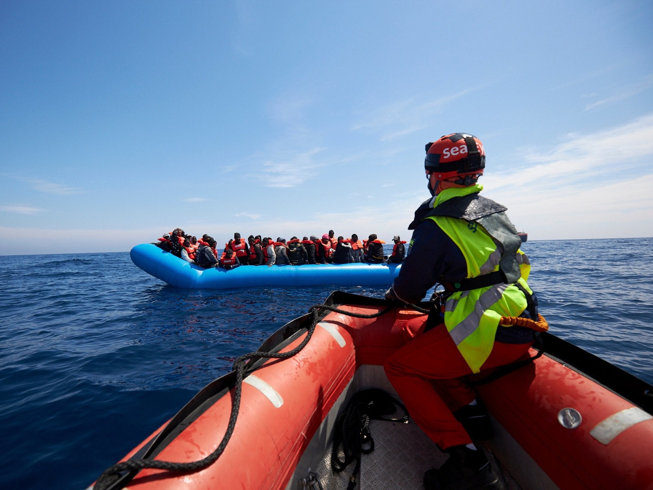 Refugees on a rubber dinghy are rescued by Sea Watch in the waters off Libya