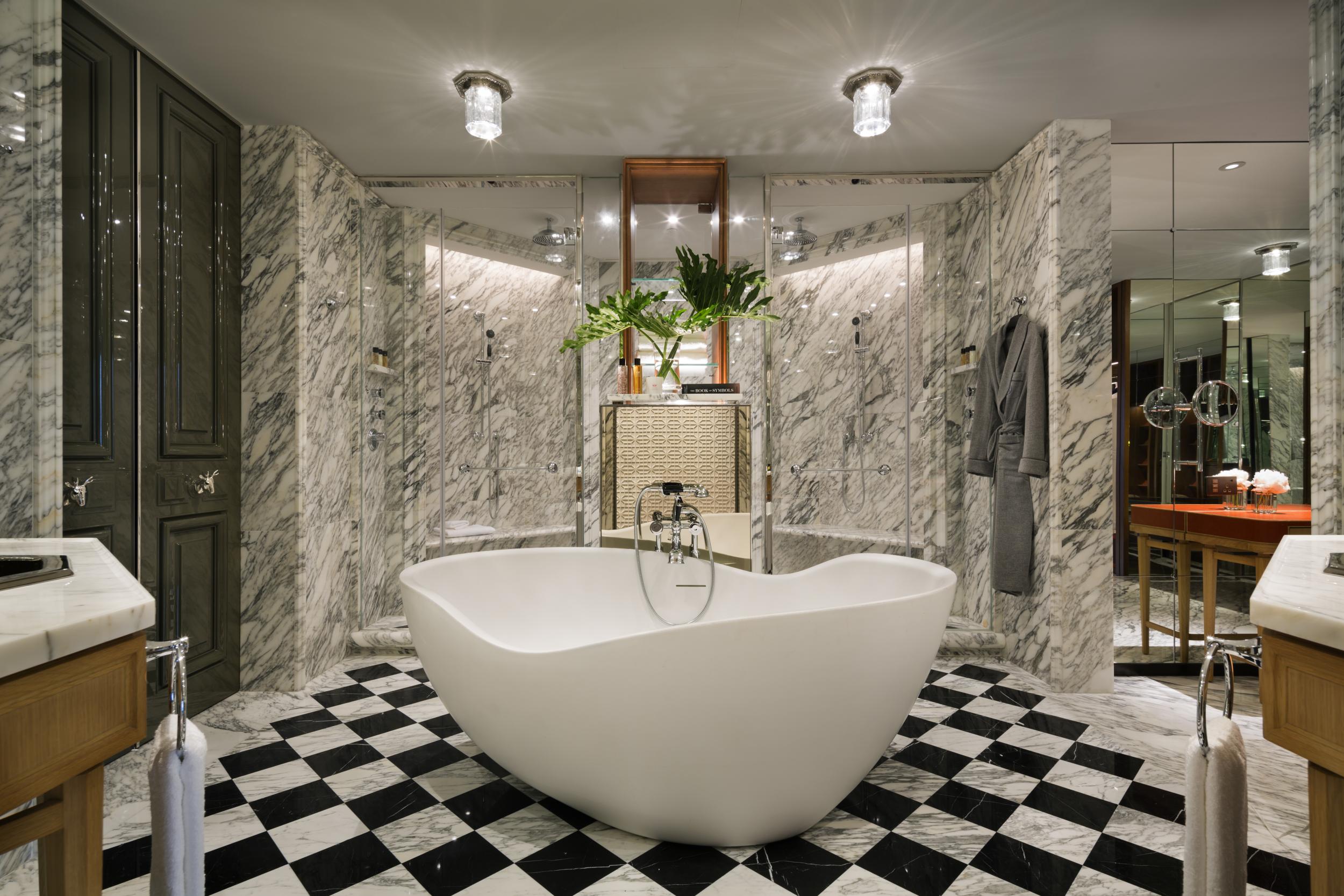 A suite bathroom, with freestanding bath and dual showers