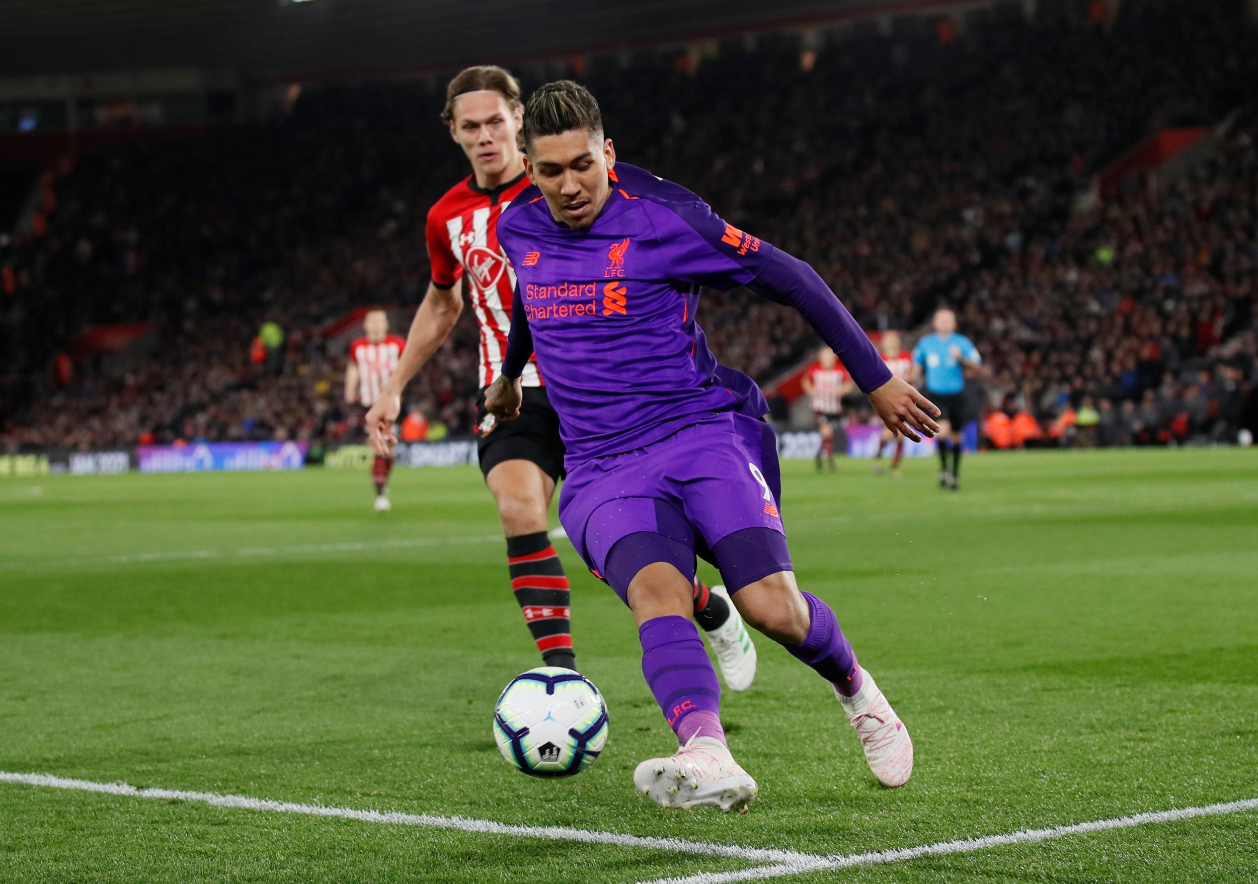 Roberto Firmino works to keep the ball in touch