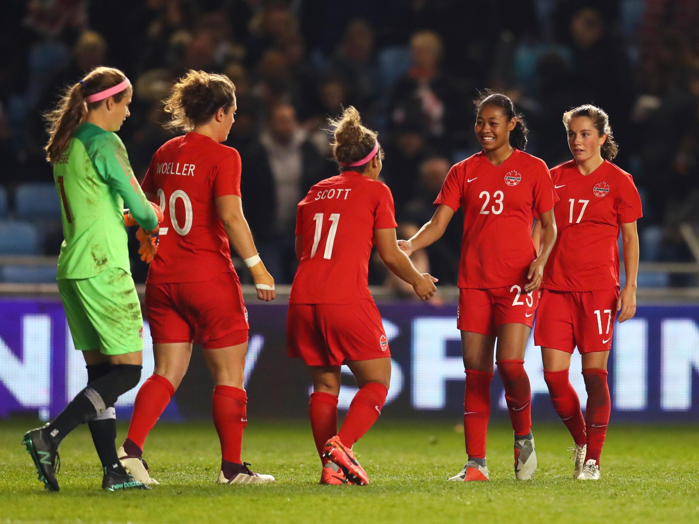 Canada's players celebrate victory after the final whistle