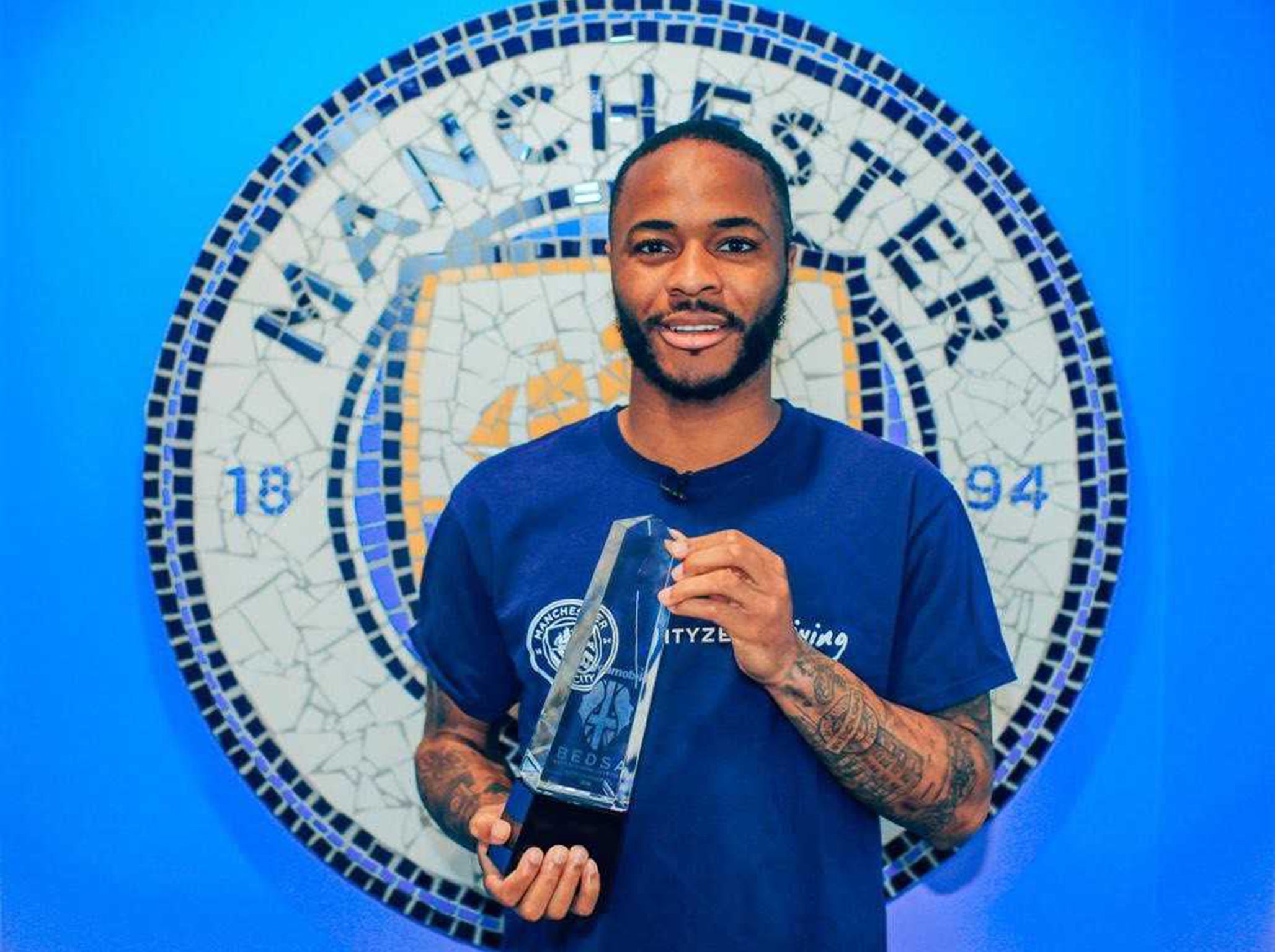 Raheem Sterling receives his award