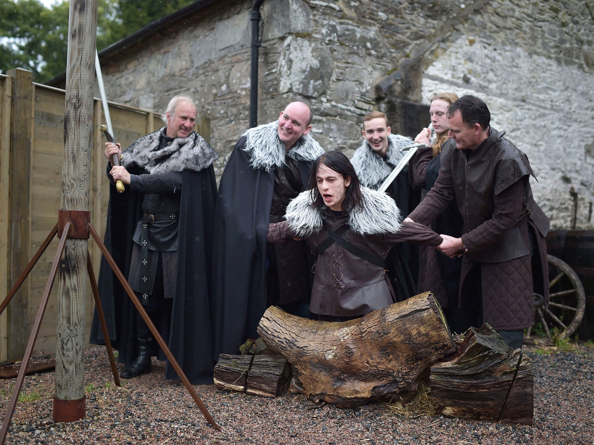 Hands-on experience: a tour instructor prepares to ‘behead’ a tourist at Castle Ward (Getty)