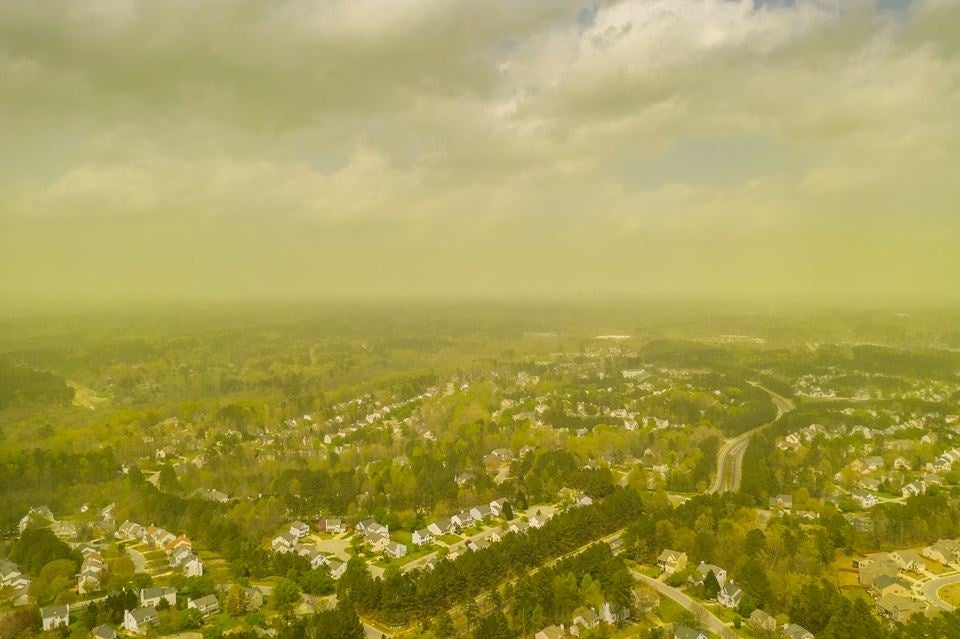 An aerial view shows pollen haze tinting the environment yellow over an area in Durham, North Carolina, U.S., April 8, 2019