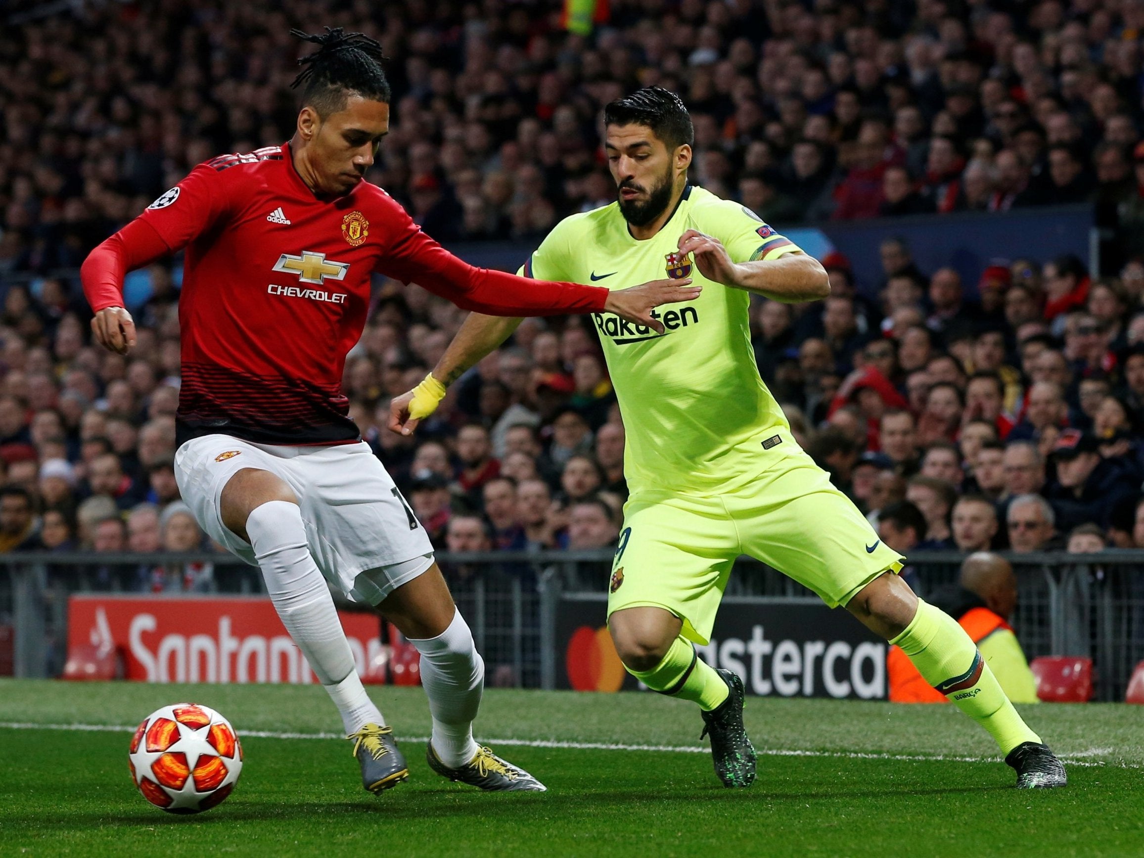 Luis Suarez takes on Chris Smalling early in the game