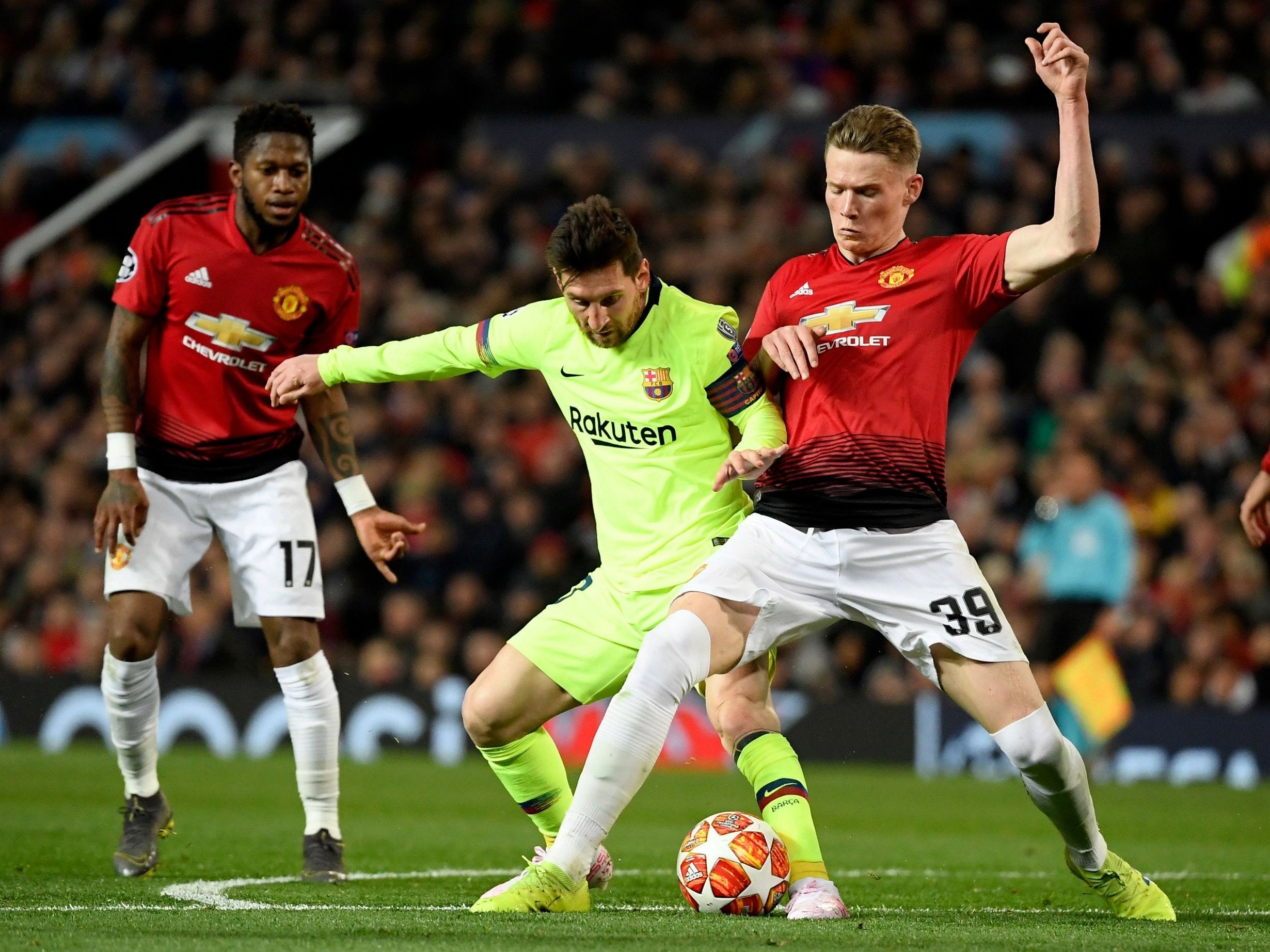 Scott McTominay battles with Lionel Messi for the ball