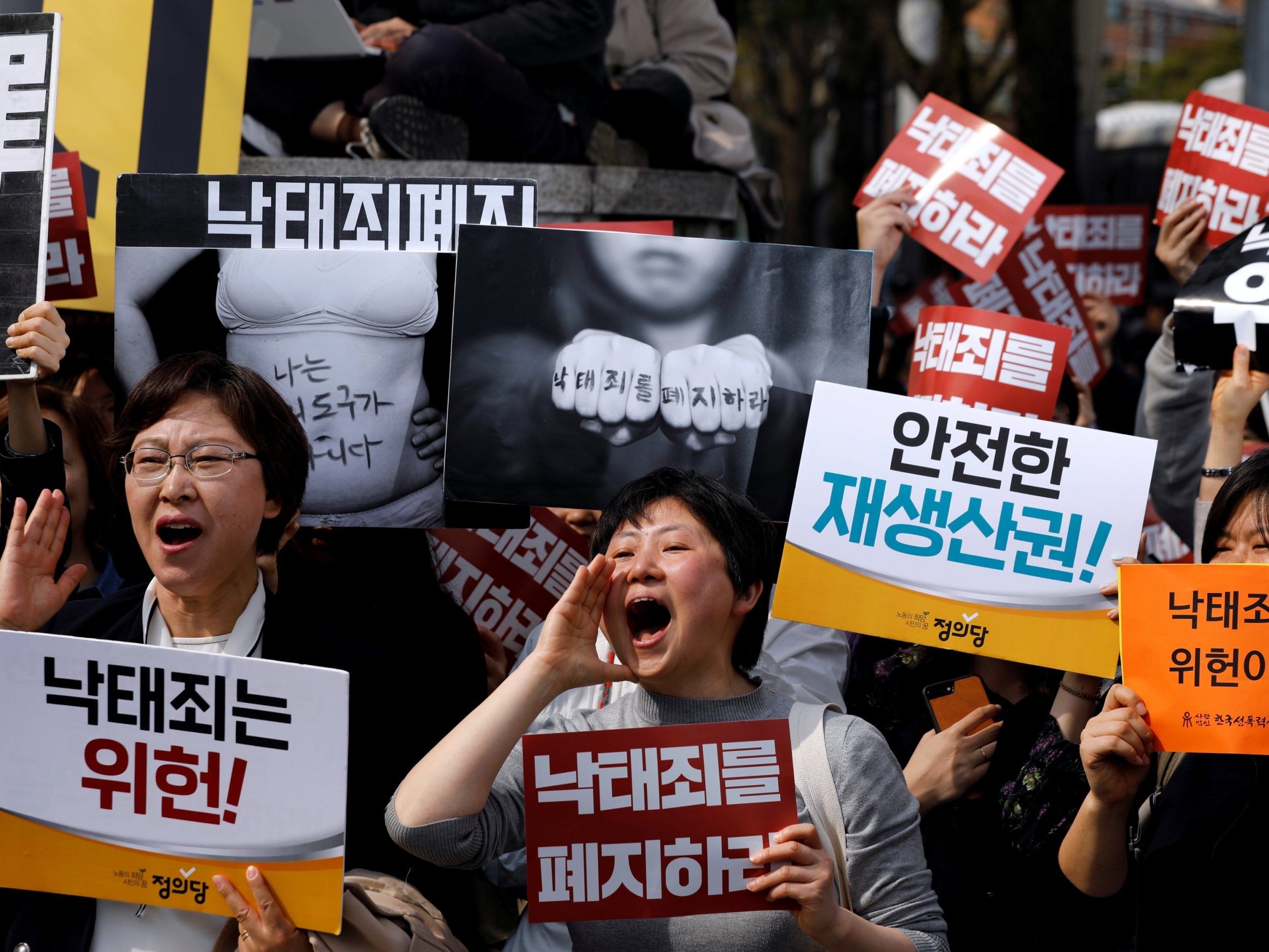 Anti-abortion law protesters react after hearing the court ruling. The banner reads ‘We are not a tool for giving birth’