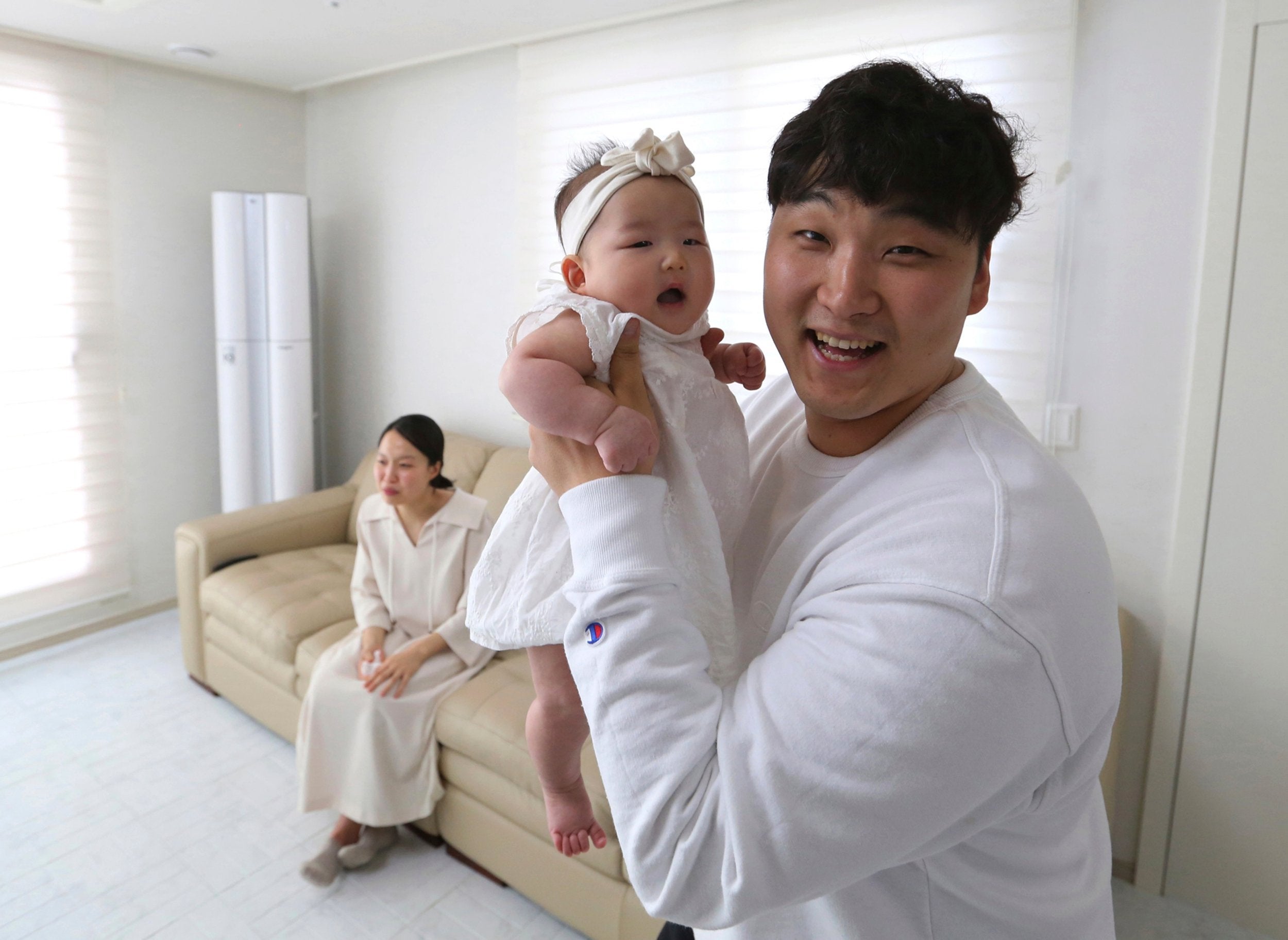 Lee Dong Kil holds his daughter Lee Yoon Seol who turned two just two hours after she was born