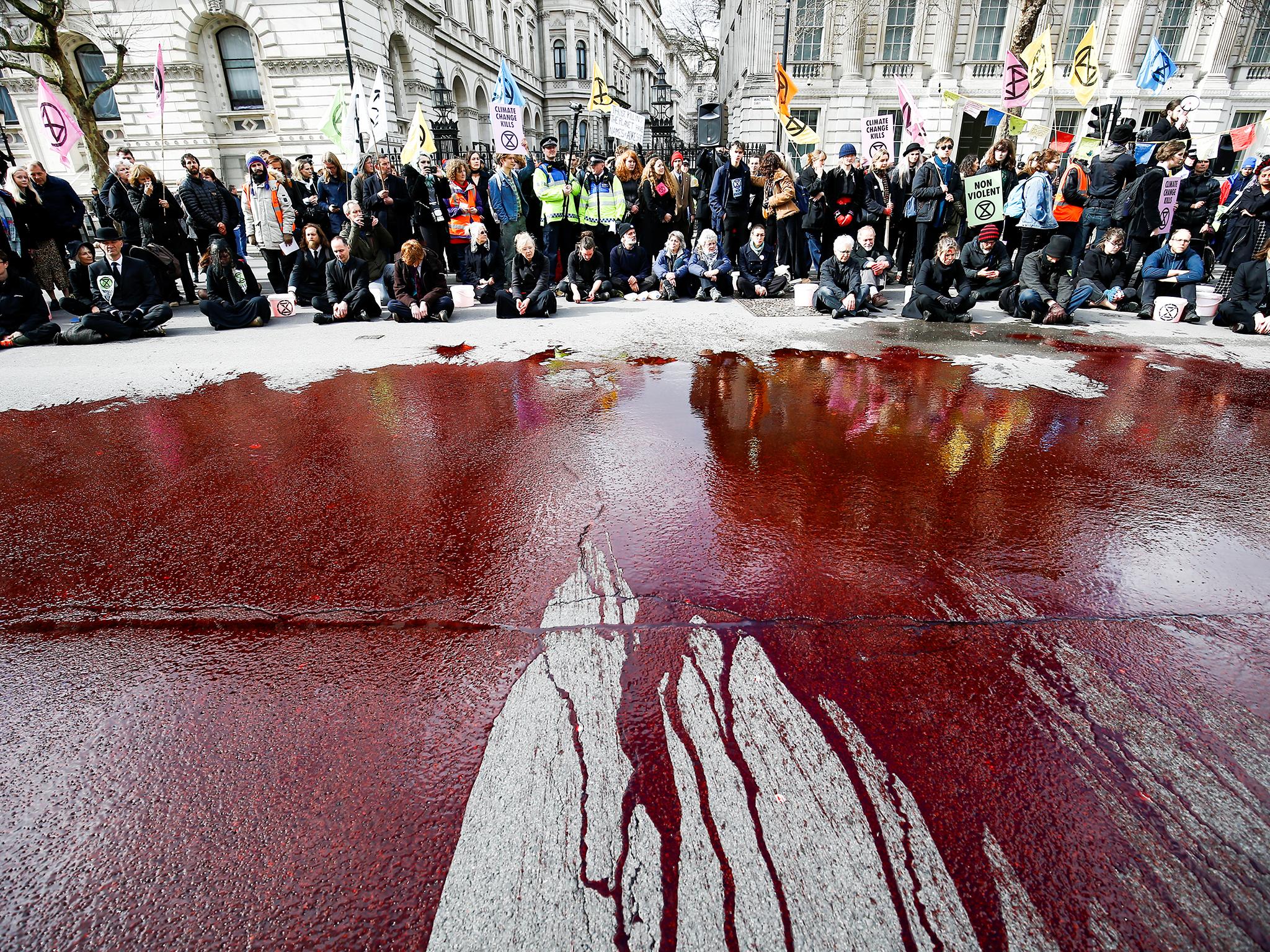 ‘Viscerally clear’: fake blood thrown by XR outside parliament symbolises the deaths climate change will cause (Reuters)