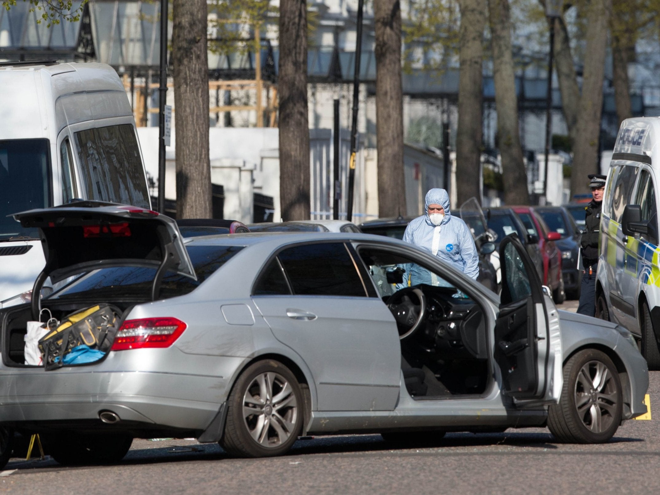 Forensic officers at scene near the Ukrainian Embassy in Holland Park, west London after police fired shots after the ambassador's car was "deliberately rammed"