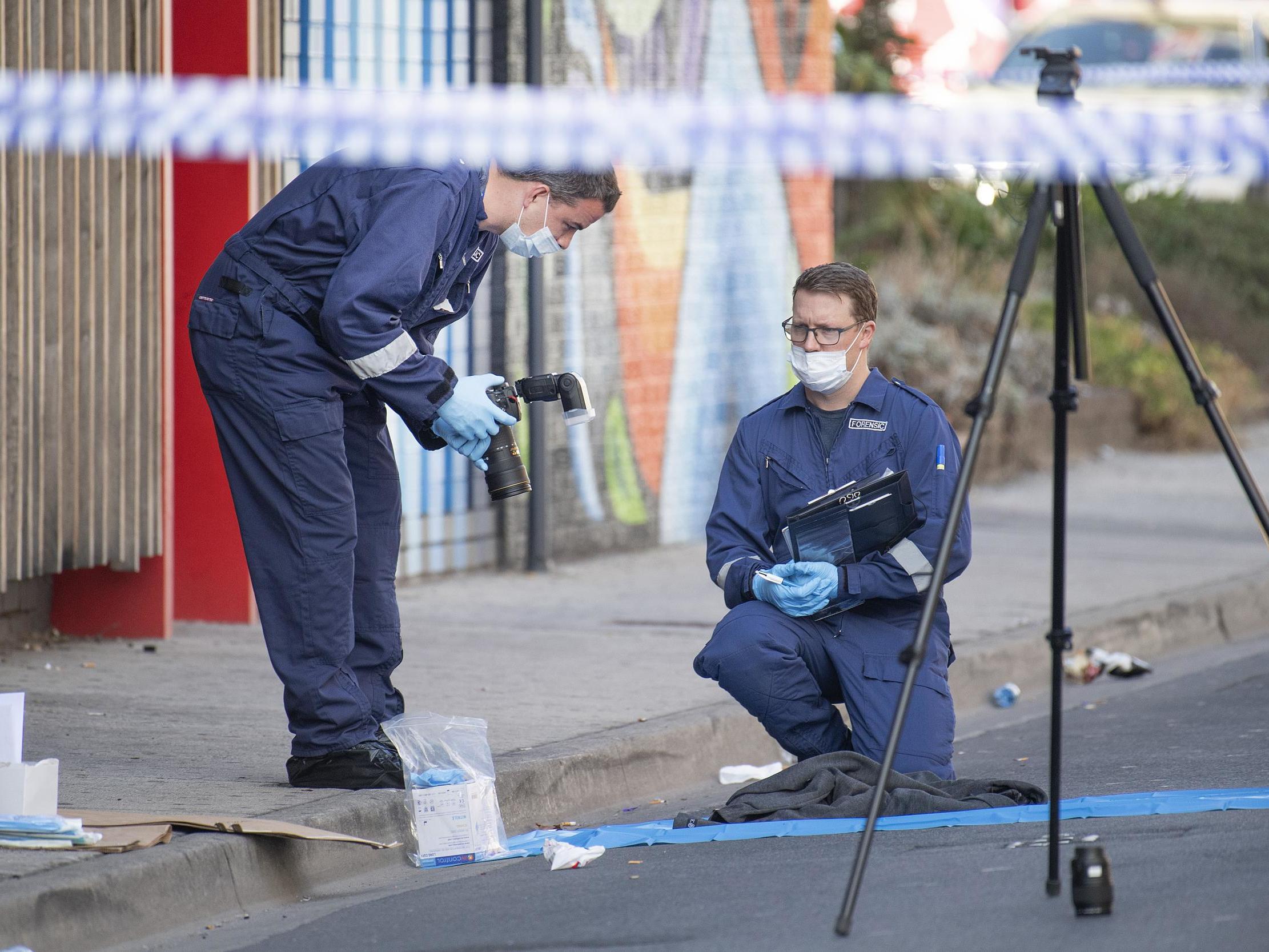 Forensic police examine items at the scene of a multiple shooting outside Love Machine nightclub in Melbourne