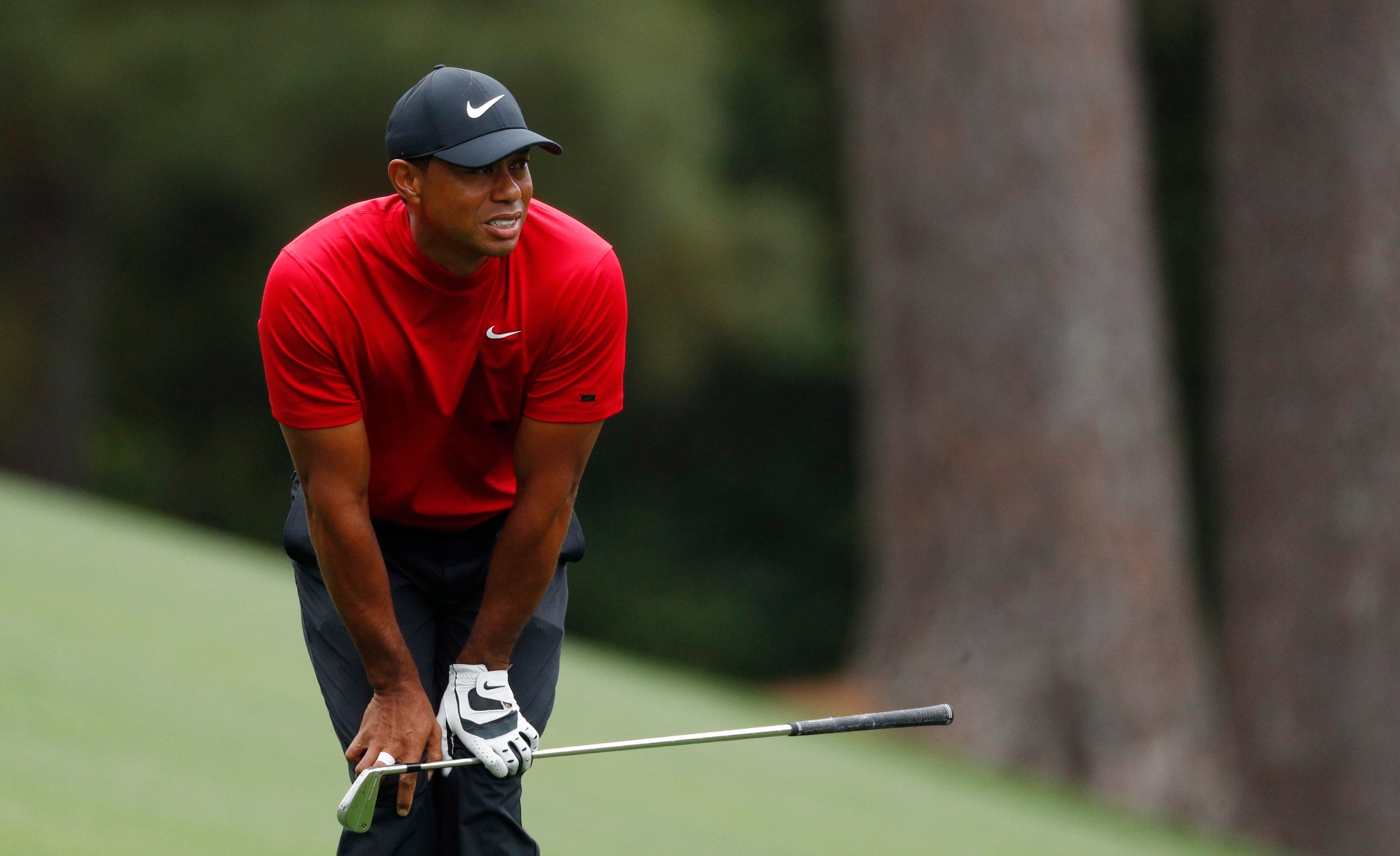 Woods reacts after missing the green at the par-5 second