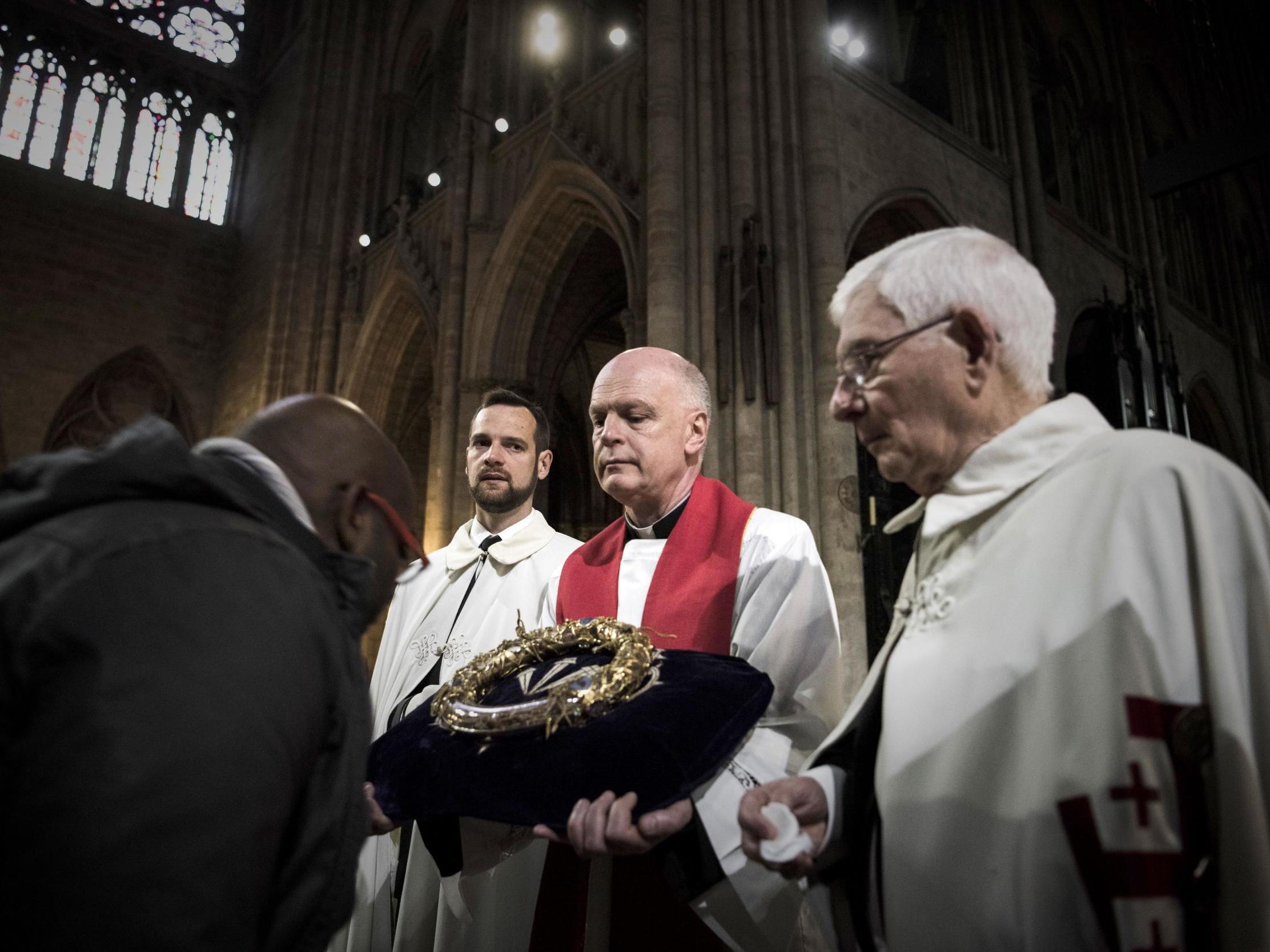 A priest held the Crown of Thorns as the relic was presented to worshippers in 2017