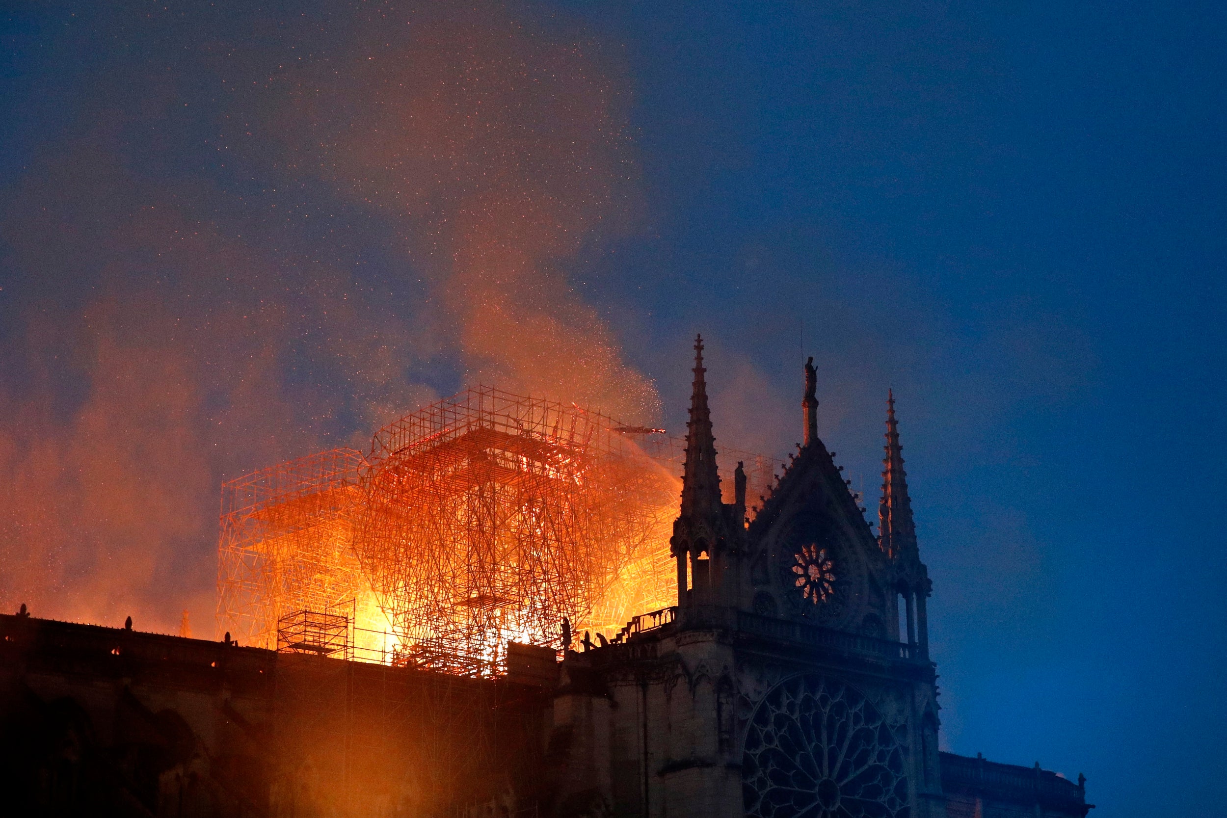 Crowds of tourists and Parisians watched in horror as the spire and roof of Notre Dame cathedral came crashing down to the ground.