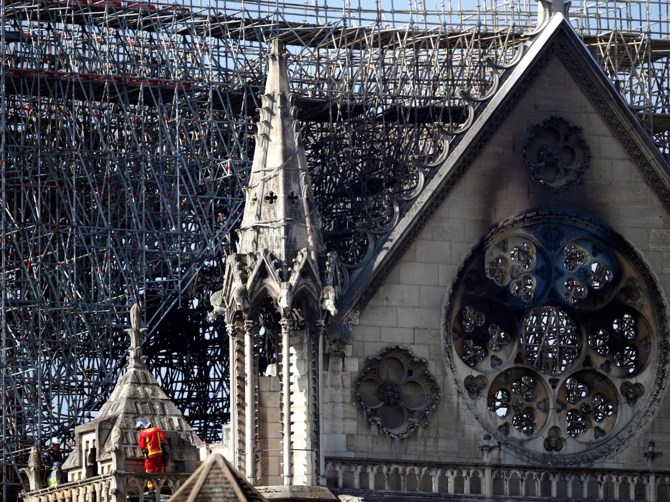 A fire fighter makes his way on a balcony of Notre Dame cathedral Wednesday