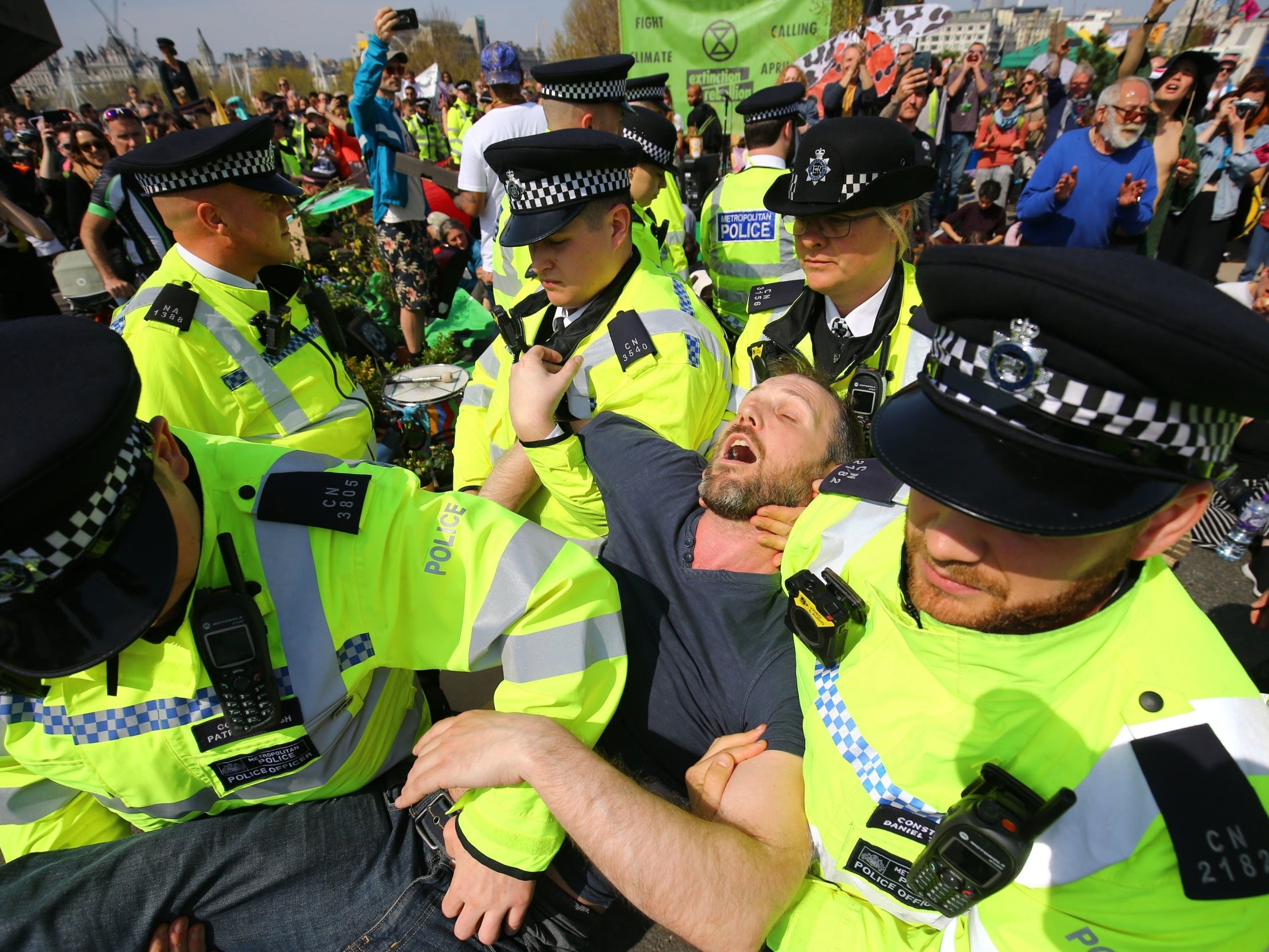 An Extinction Rebellion protester being carried away by police in London